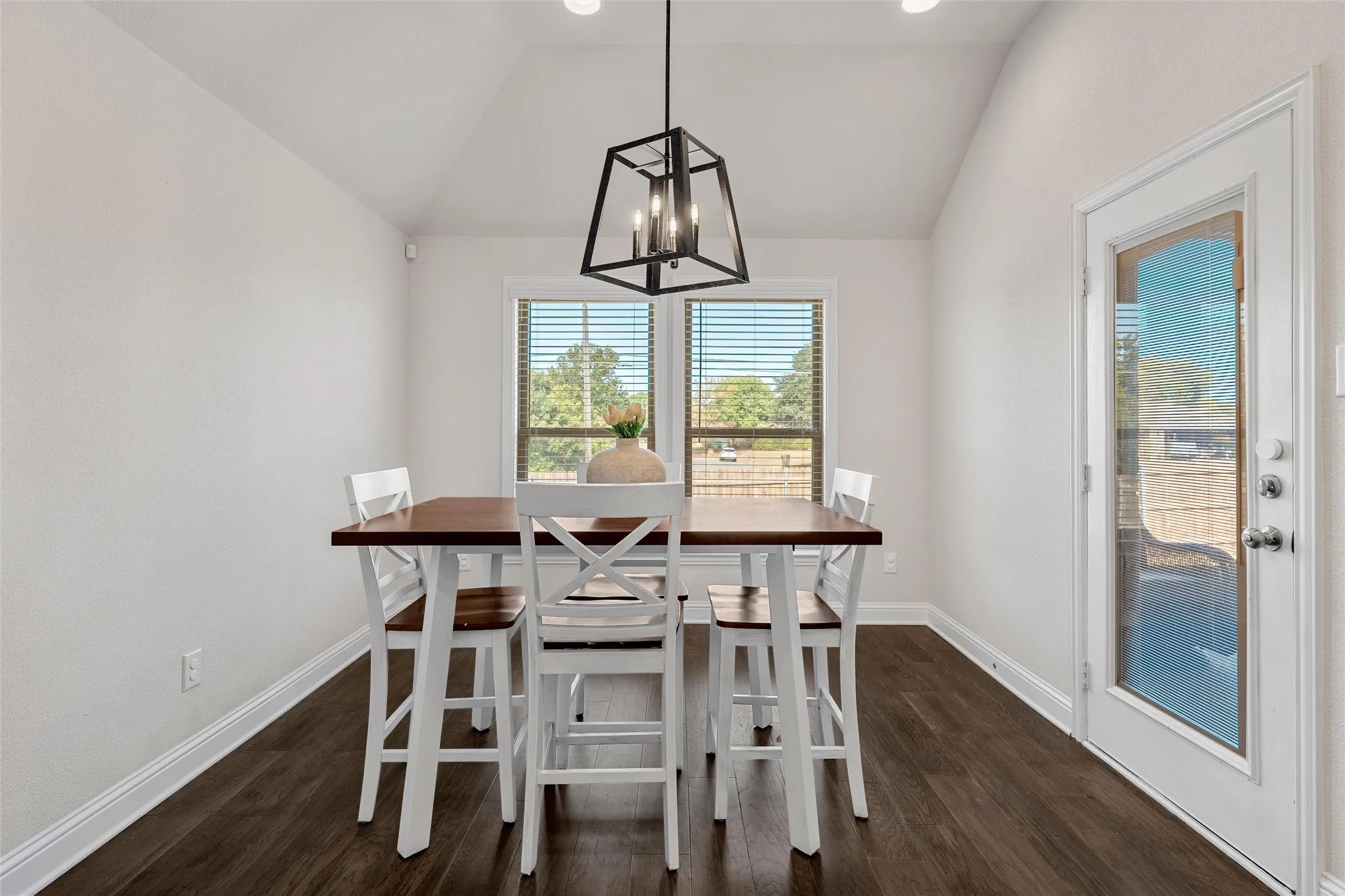Vaulted ceiling featuring a modern geometric pendant light fixture