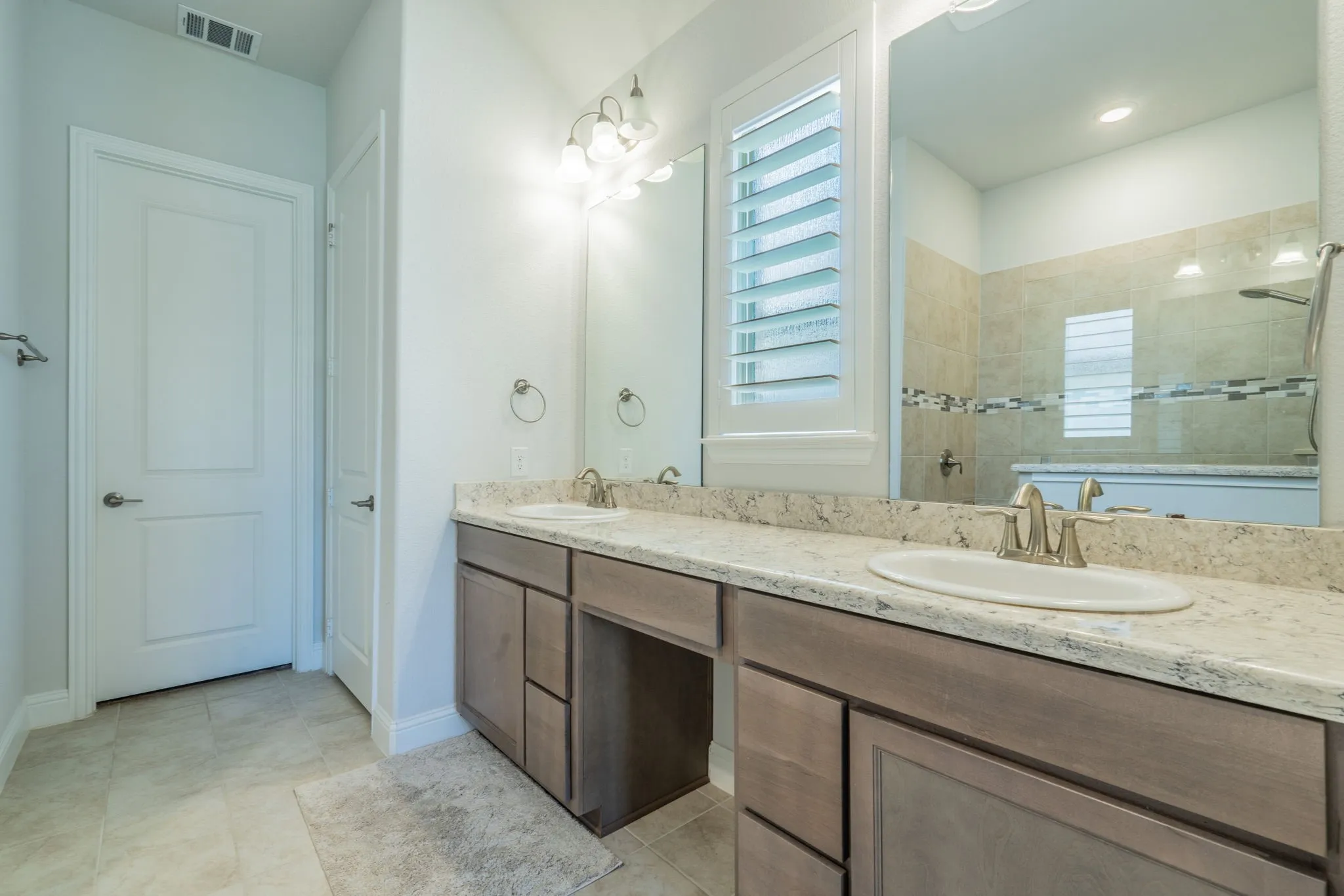 Dual vanity with neutral-toned countertops and undermount sinks