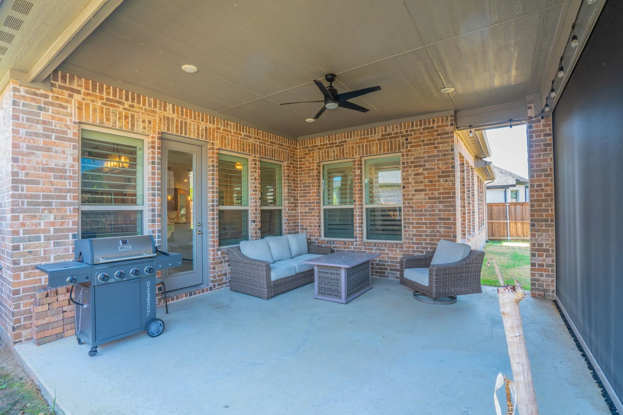 Covered patio with a ceiling fan, recessed lighting, brick exterior, and concrete flooring