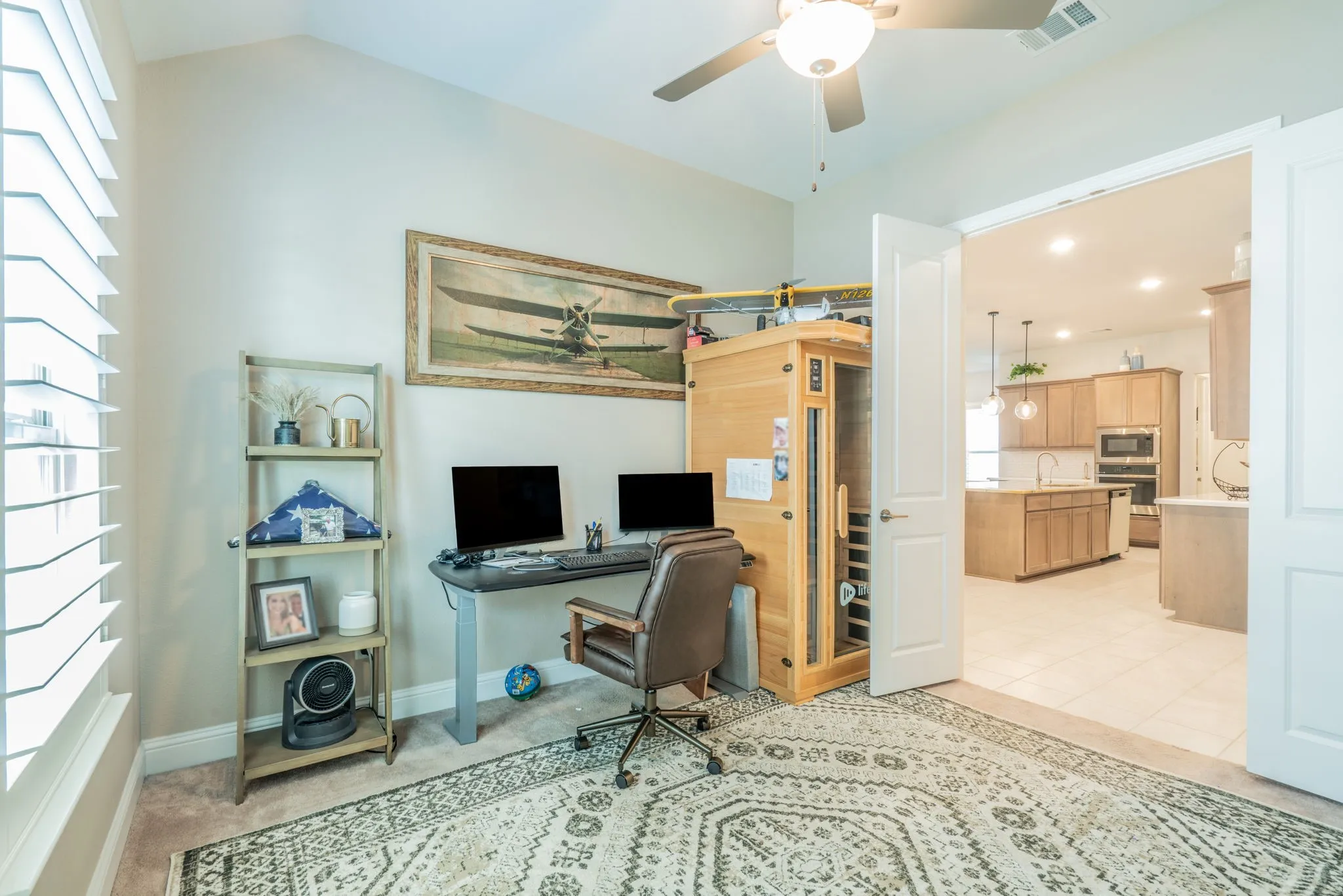 Vaulted ceiling with a ceiling fan, plantation shutters, and a double-door entry