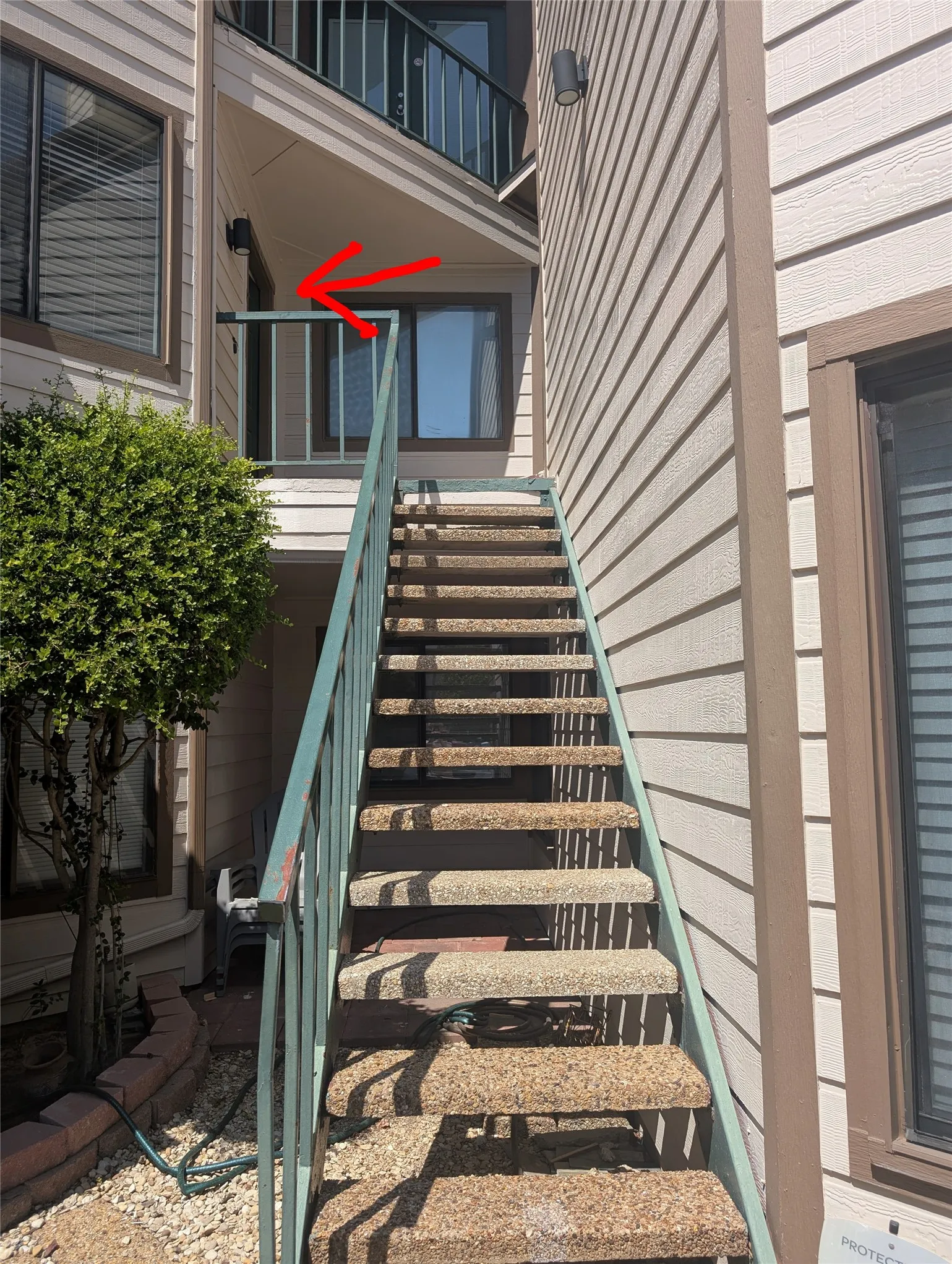 Exterior staircase with metal railings and textured treads