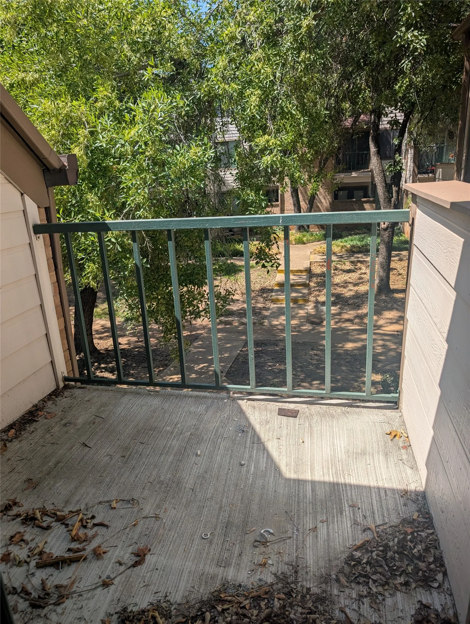 Private balcony with concrete flooring and metal railings