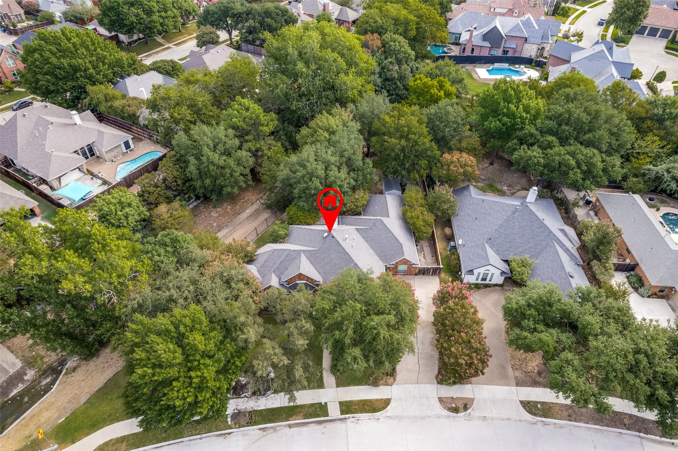 Expansive property featuring mature trees, a private driveway, and a gabled roofline