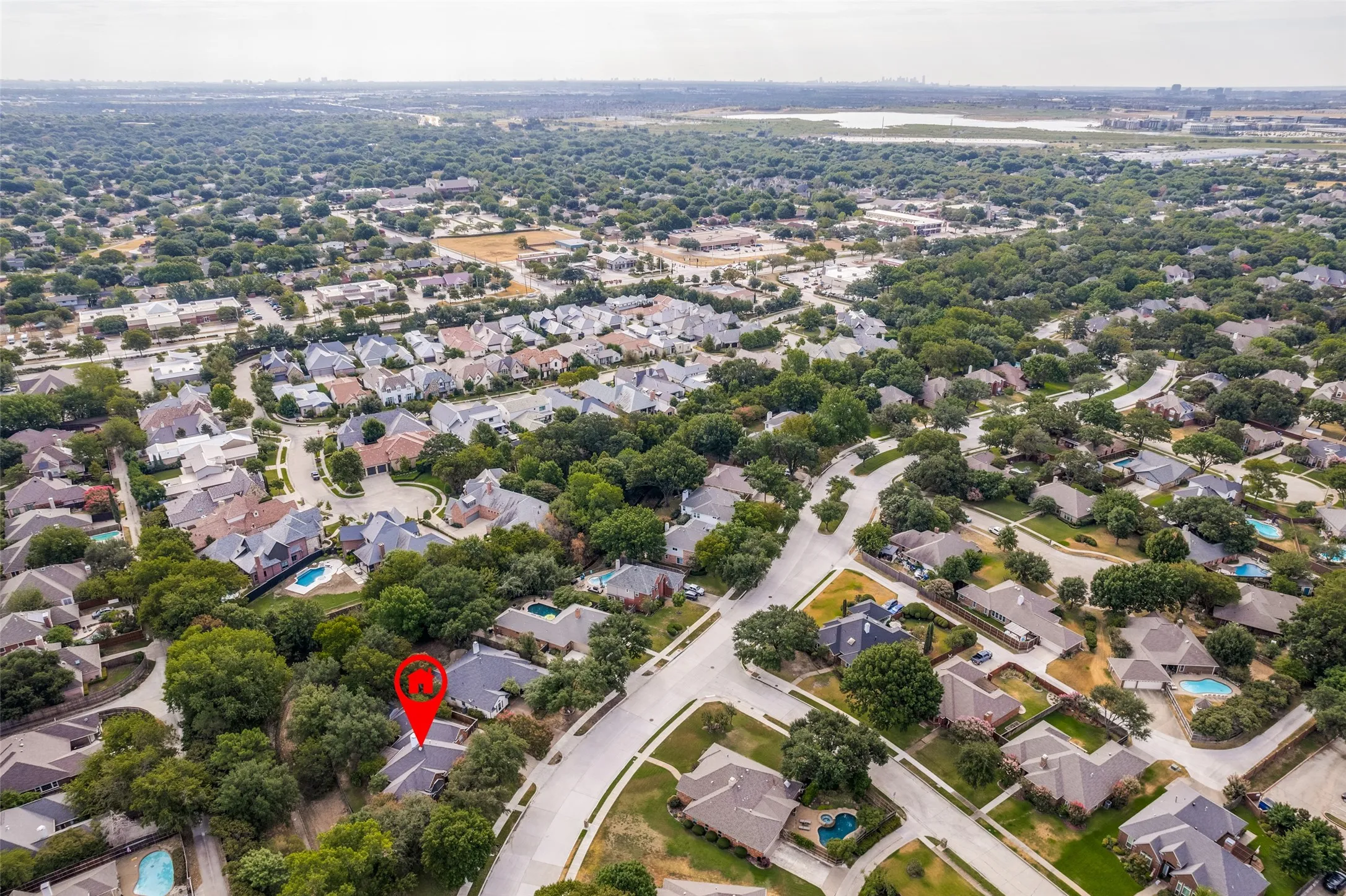 Expansive residential area with mature tree canopy and winding streets