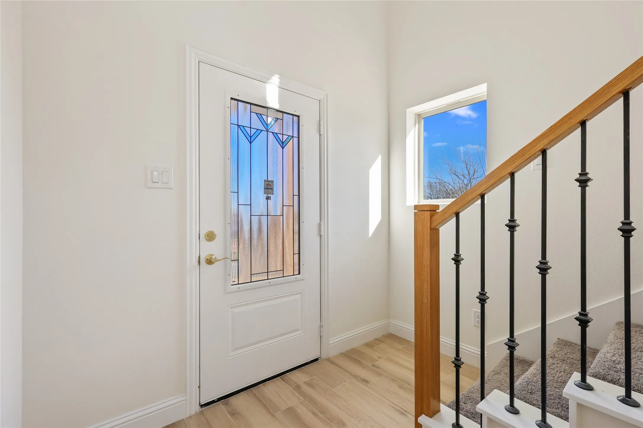 White entry door with decorative glass inserts