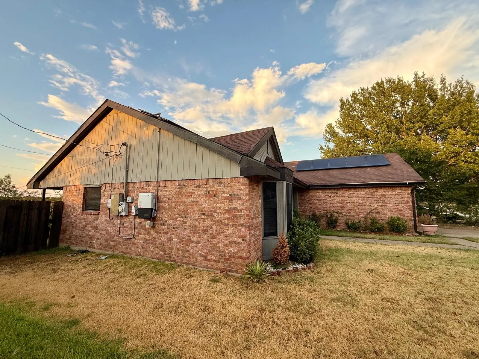 Brick exterior with a gabled roof and solar panels