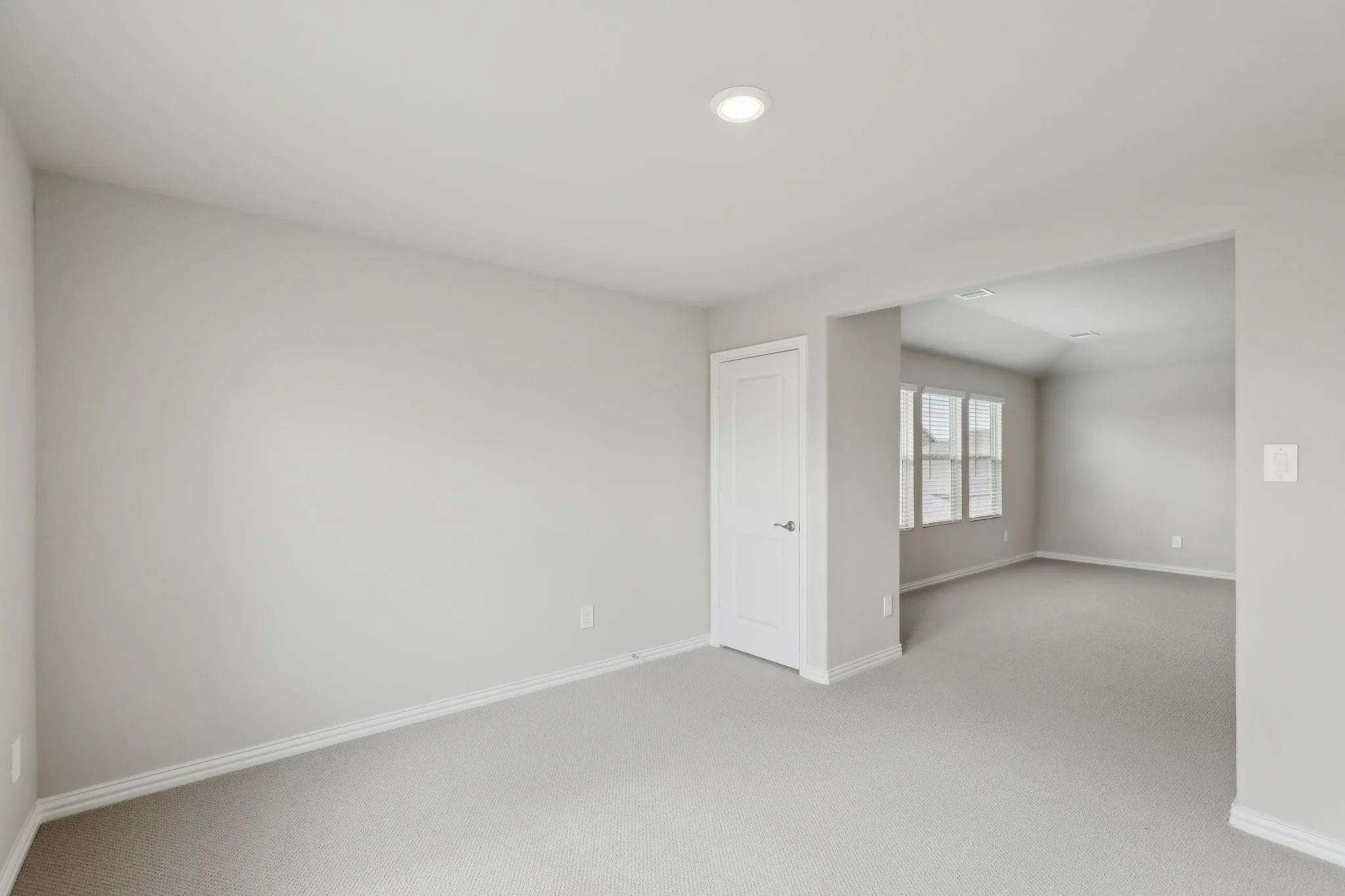 Recessed lighting, light gray carpeting, white trim, and white paneled doors