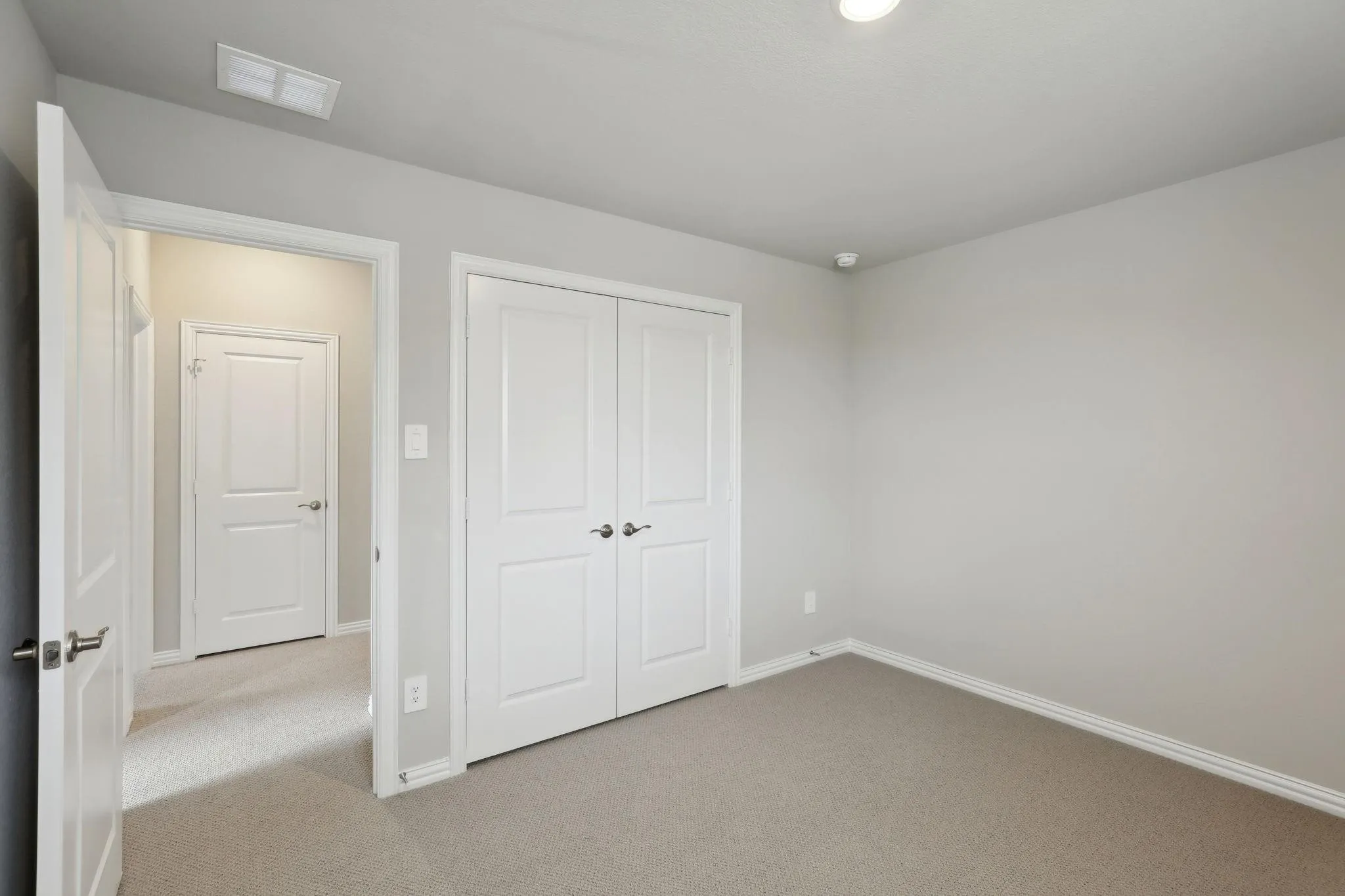 Neutral wall paint, recessed lighting, carpet flooring, and white trim