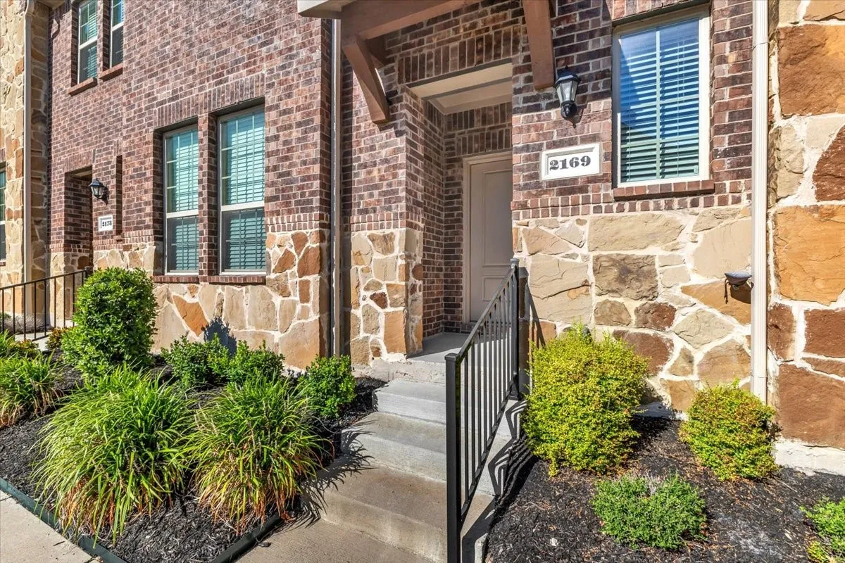 Brick and stone veneer exterior with dark window casings