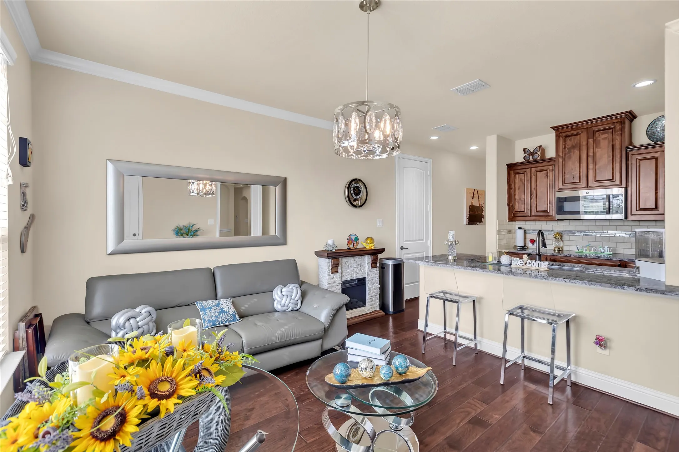 Living and Kitchen in guest suite with wood cabinetry and stainless steel appliances