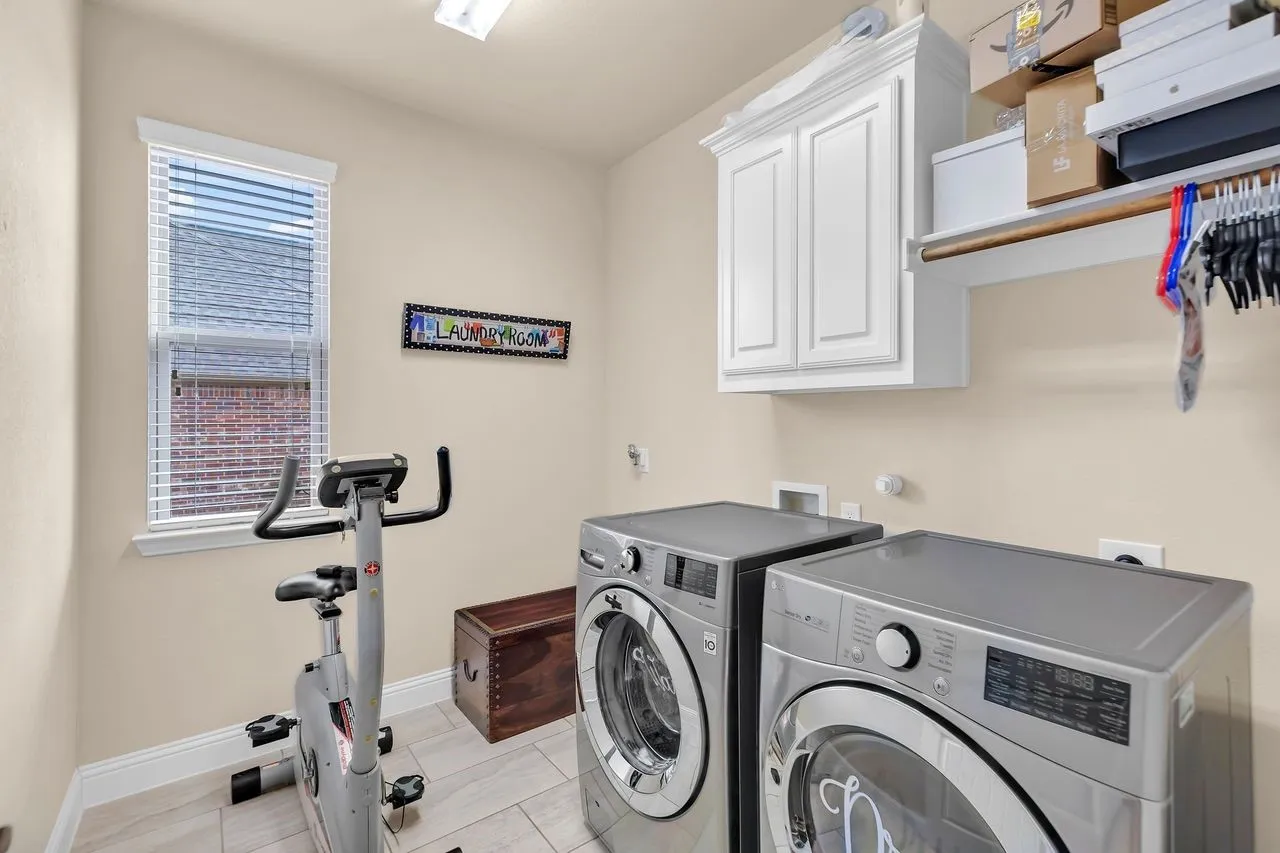 Built-in overhead white cabinetry, recessed overhead lighting, and a window with blinds.  Laundry is on 1st floor.