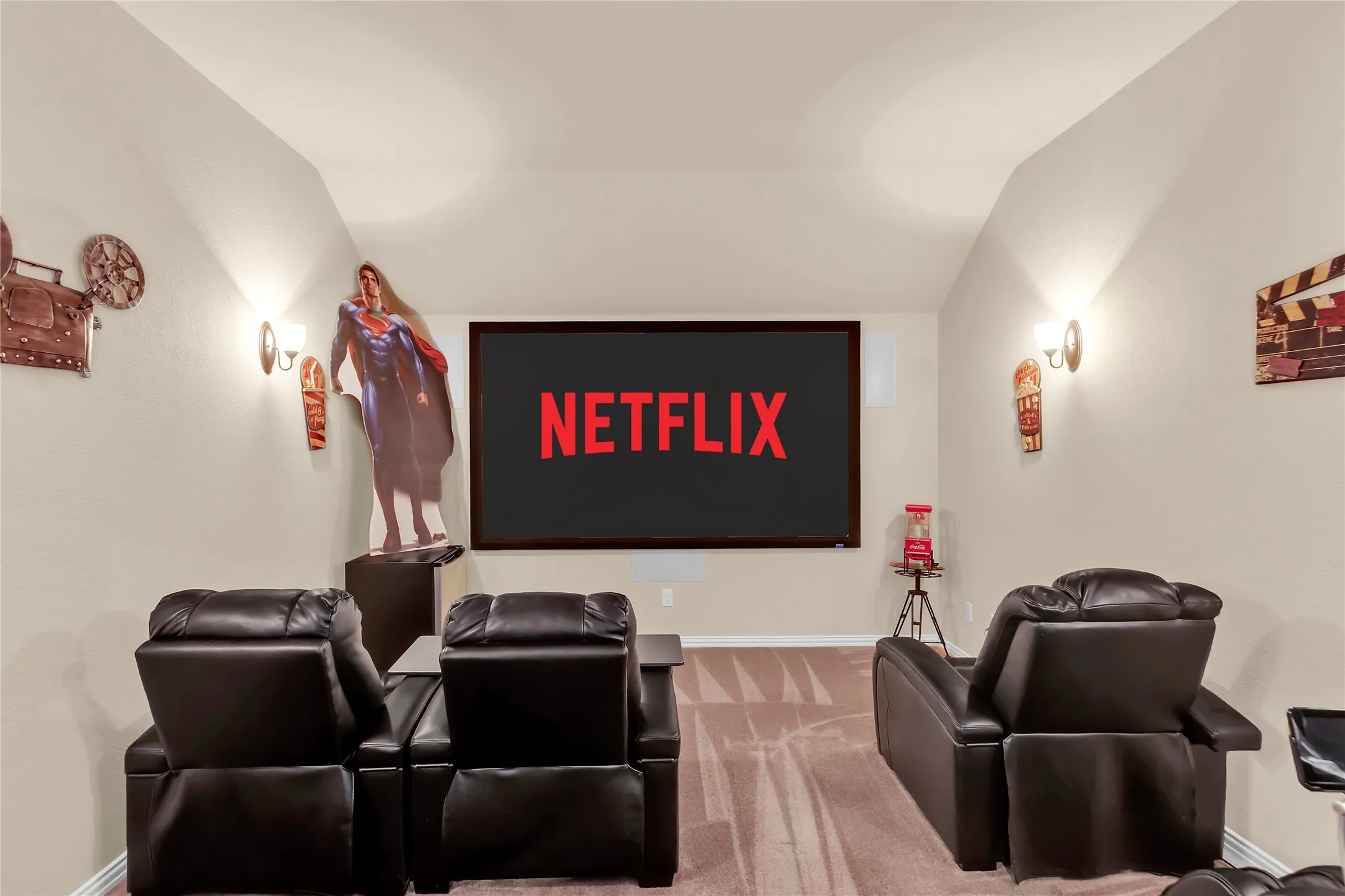 Hardwood flooring, crown molding, modern chandelier, double-paned window, and a stone-clad fireplace
