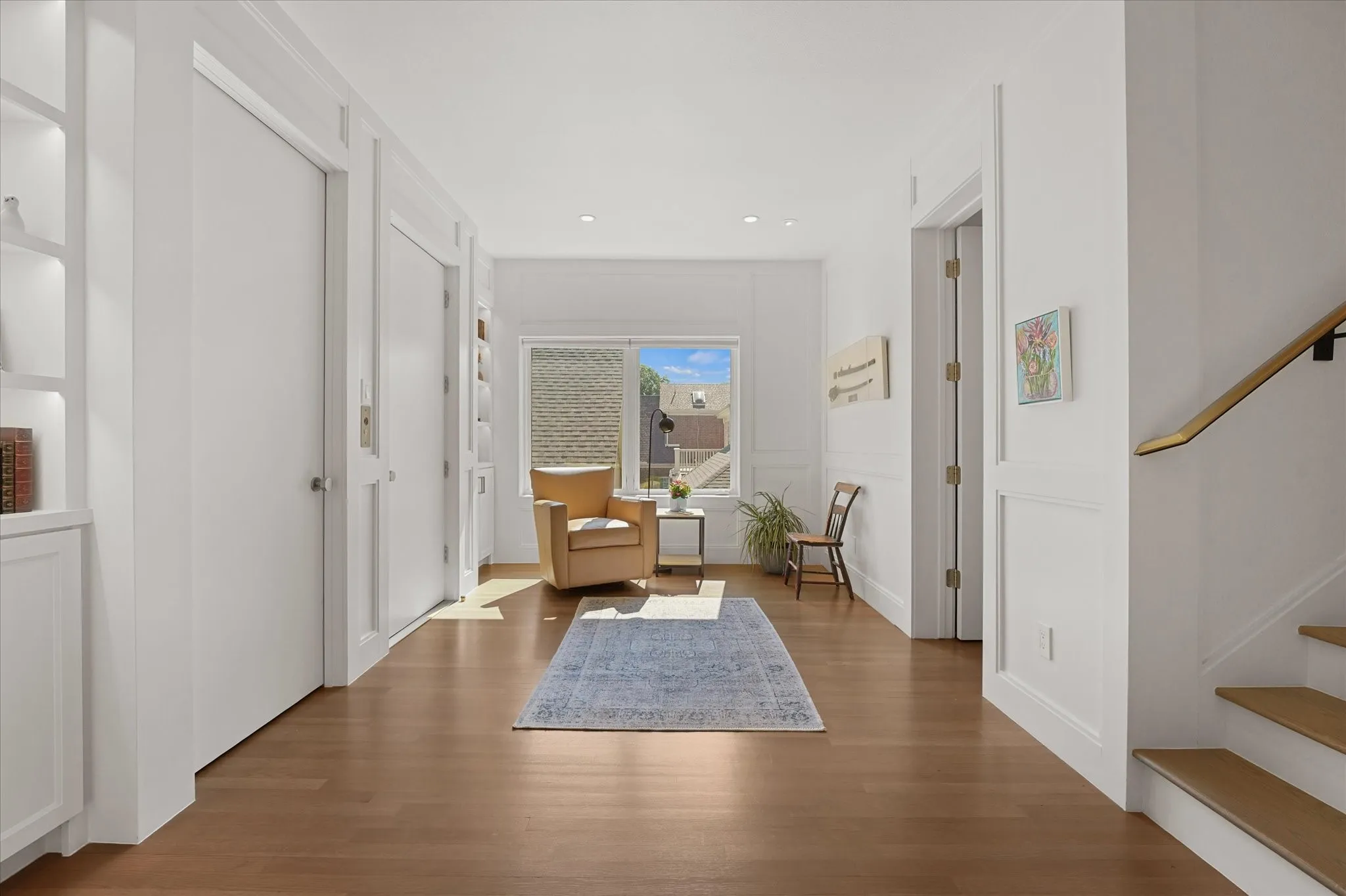 Built-in shelves with siting area with elevator access, and access to third floor.