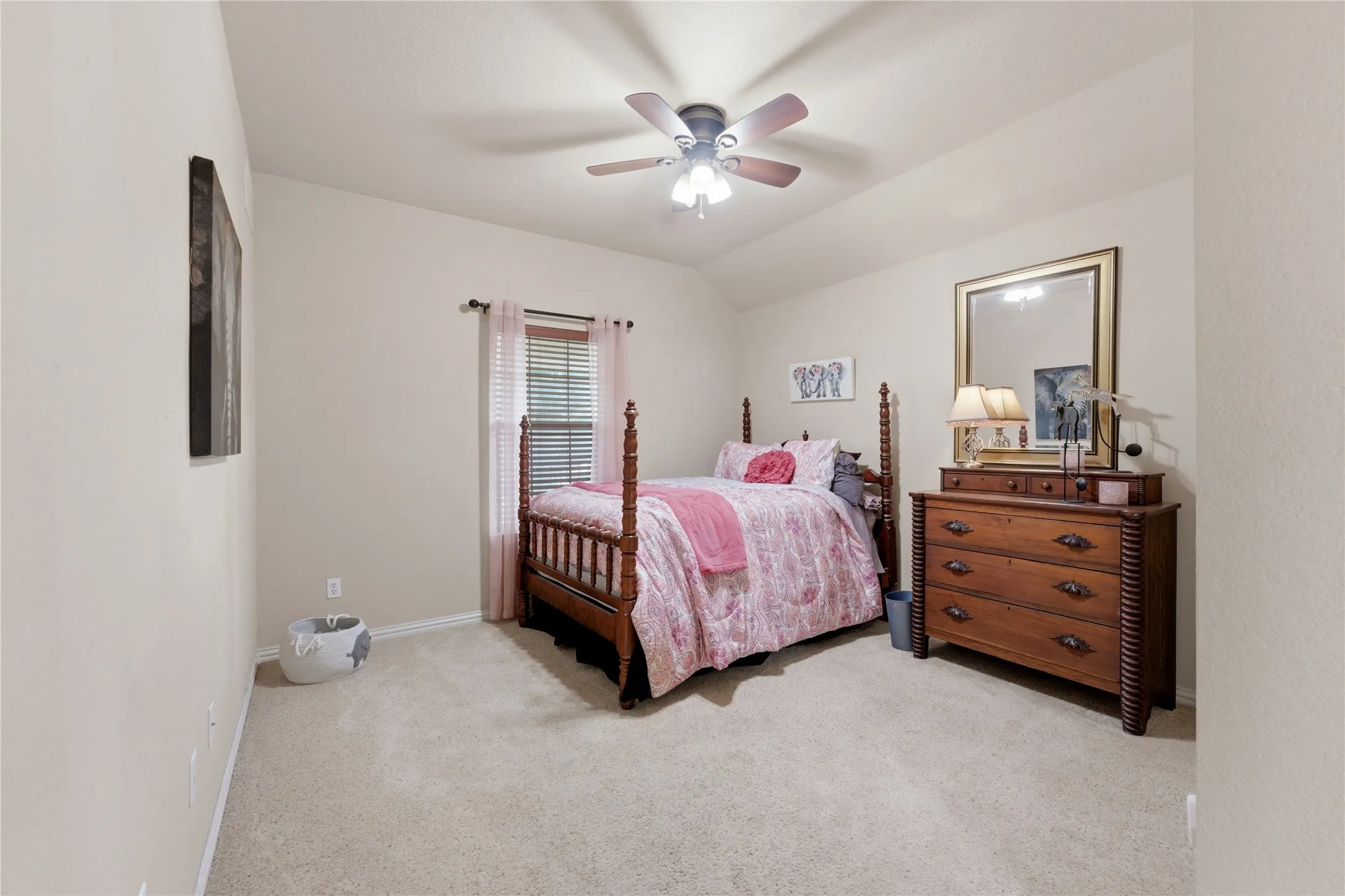 Vaulted ceiling, ceiling fan with integrated lighting, window with blinds, and carpeted flooring