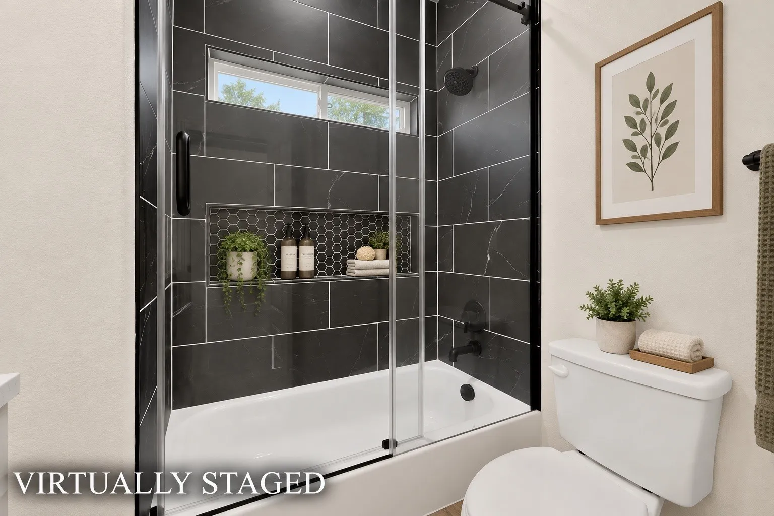 Tub with dark subway tile surround, integrated shower niche with honeycomb tile, black shower fixtures, and a glass shower enclosure