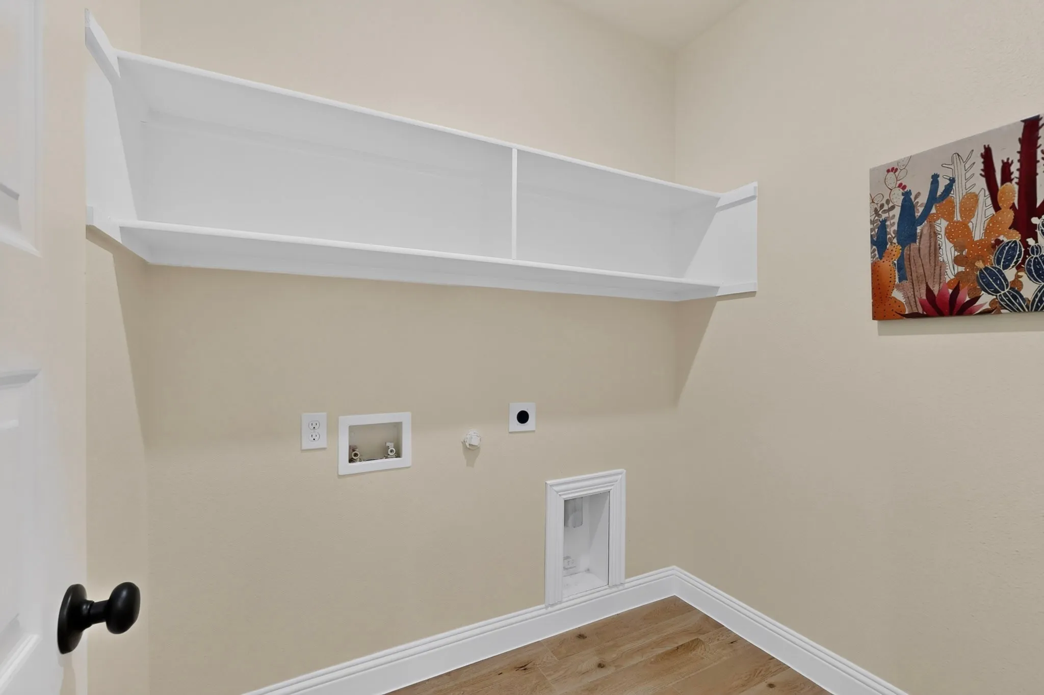 Built-in overhead shelving, wood-finish flooring, and white baseboards