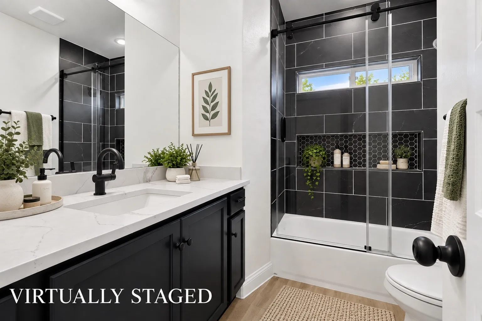 Quartz countertop vanity with black cabinetry and hardware