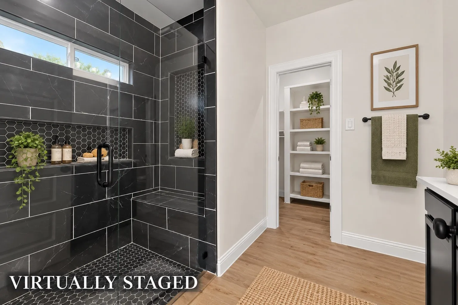 Spacious shower with dark tile and hexagonal accent, built-in bench, and clear glass enclosure