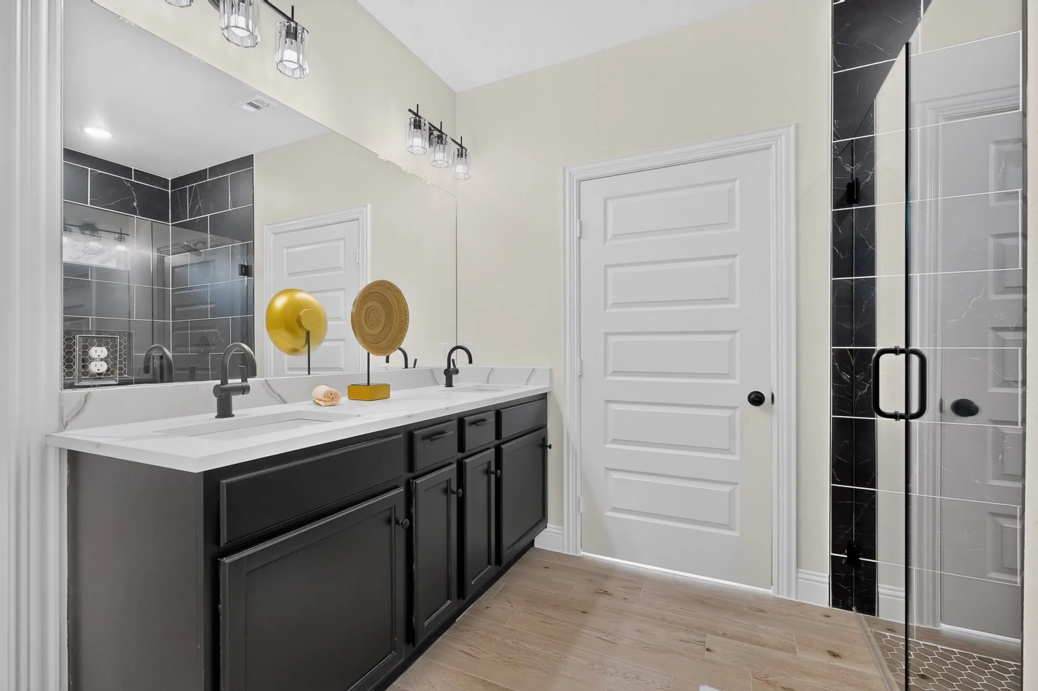 Dual vanity with a white countertop and black cabinetry