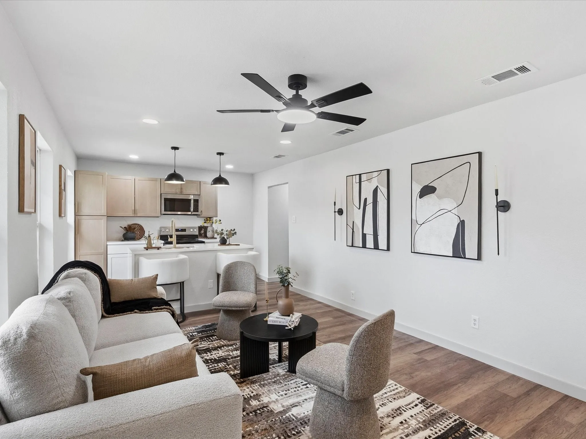 Open-concept living space with wood-finish flooring