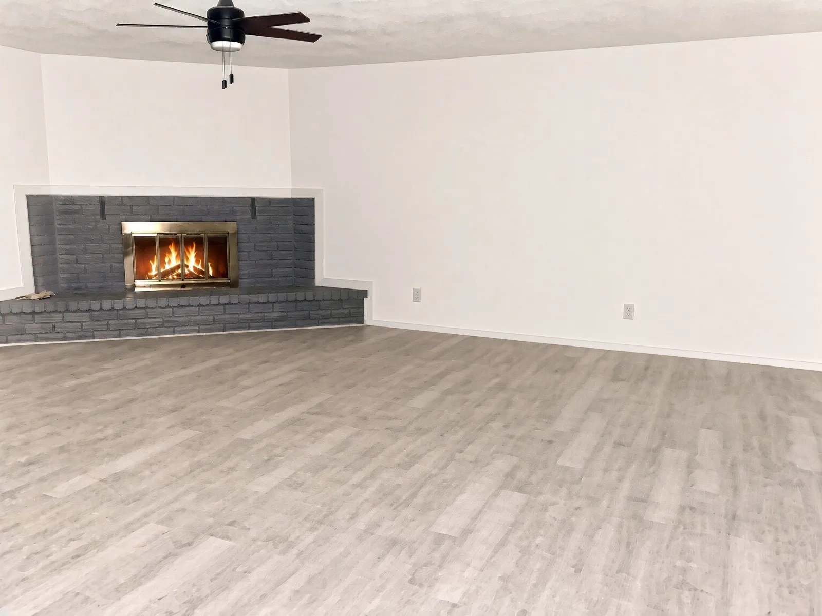 living room has corner fireplace and new flooring