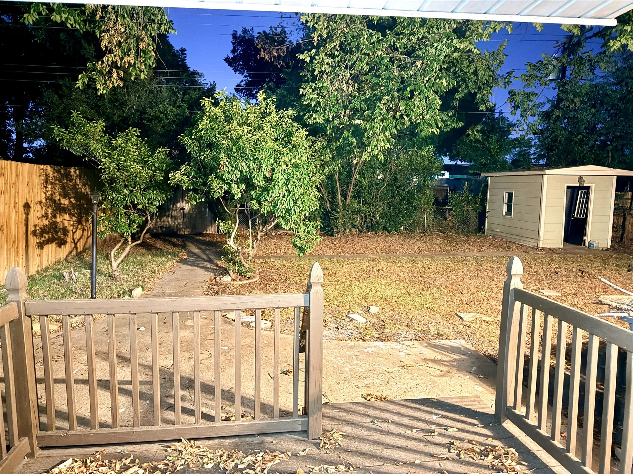big fenced yard with shed
