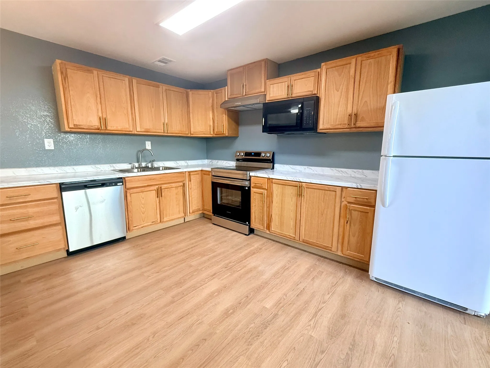 kitchen features all new cabinests, counters, flooring and appliances