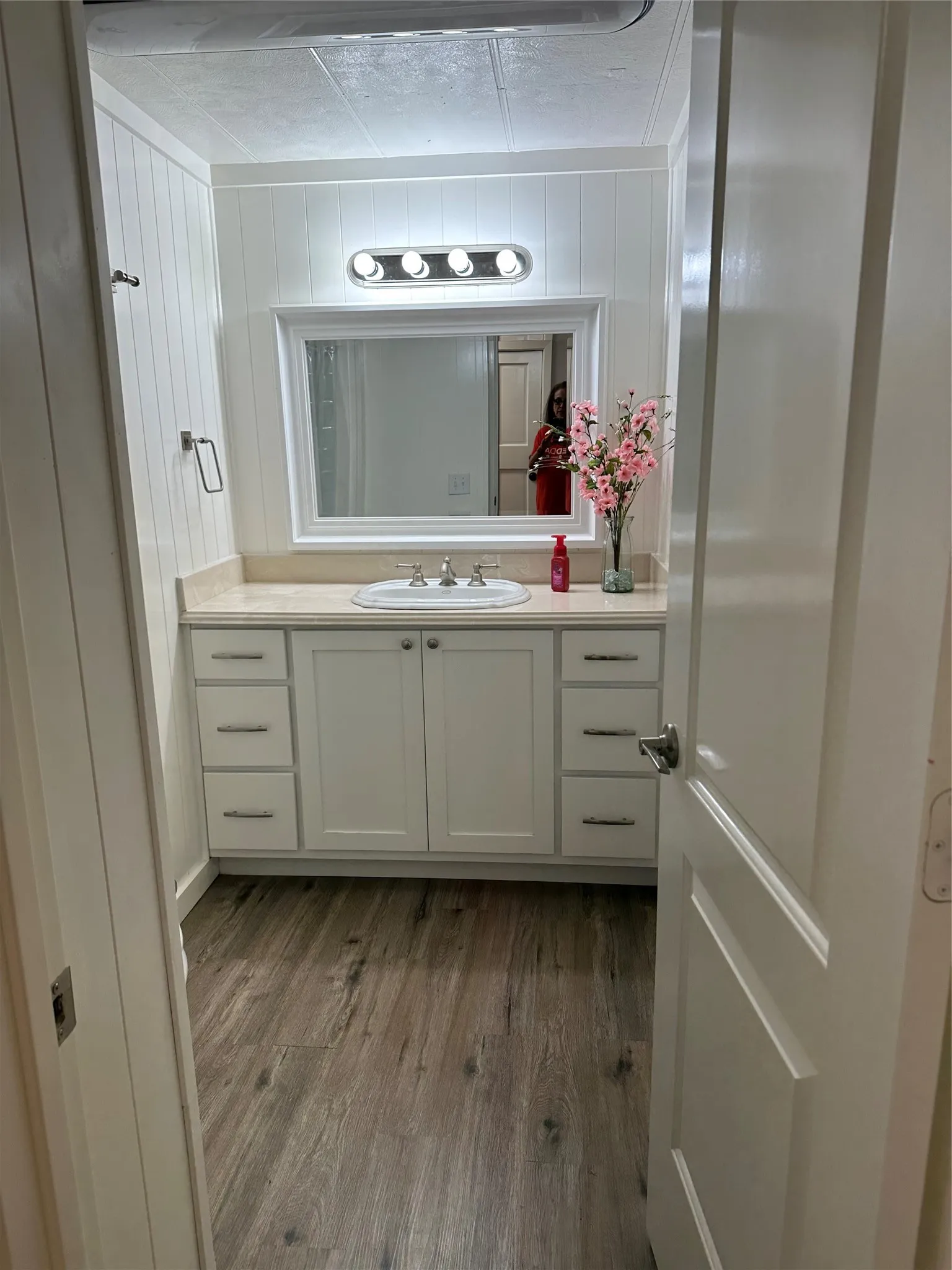 Bathroom with vanity and dark wood-style flooring