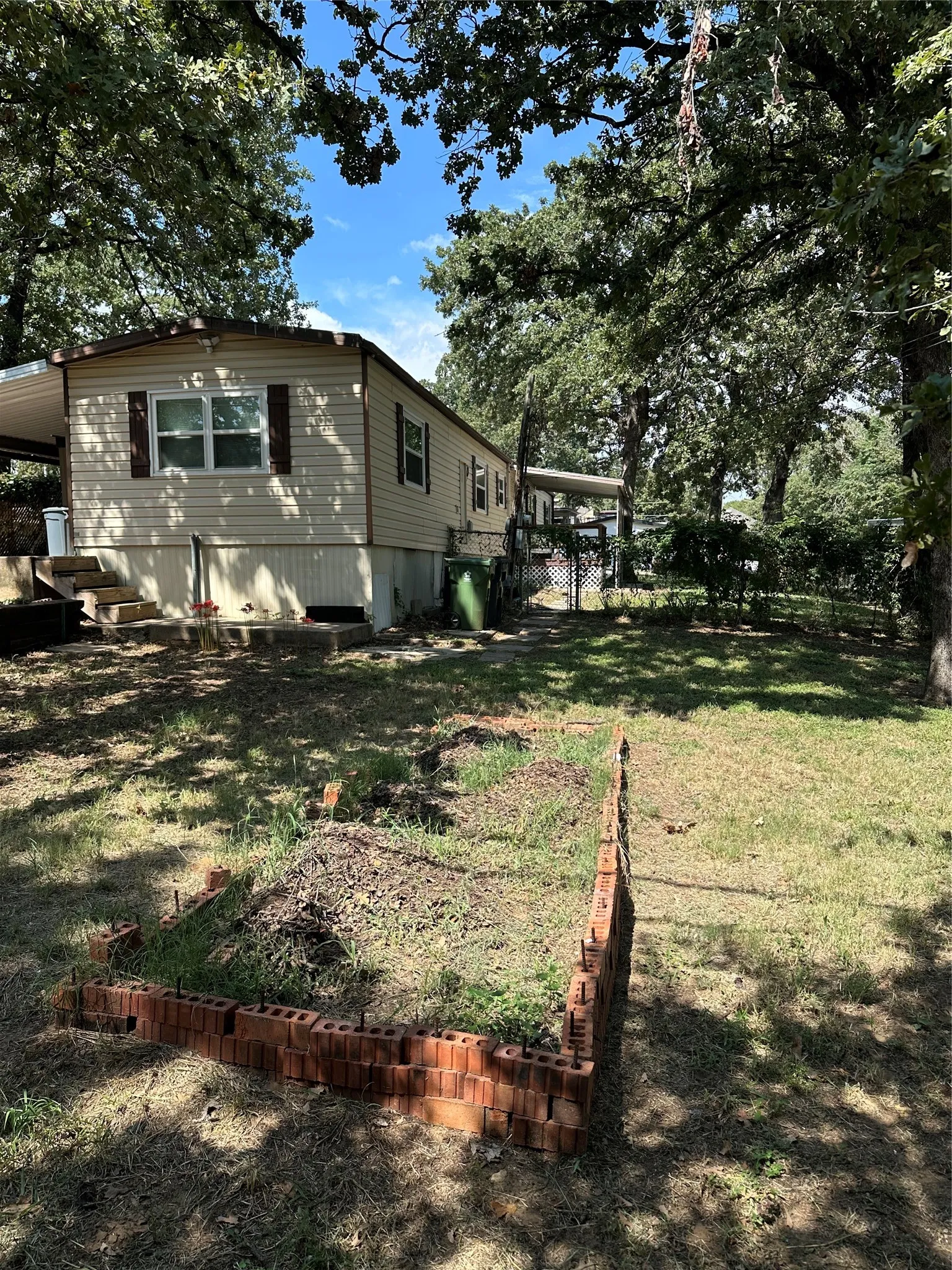 View from backyard featuring covered front and back patio areas with chainlink fence