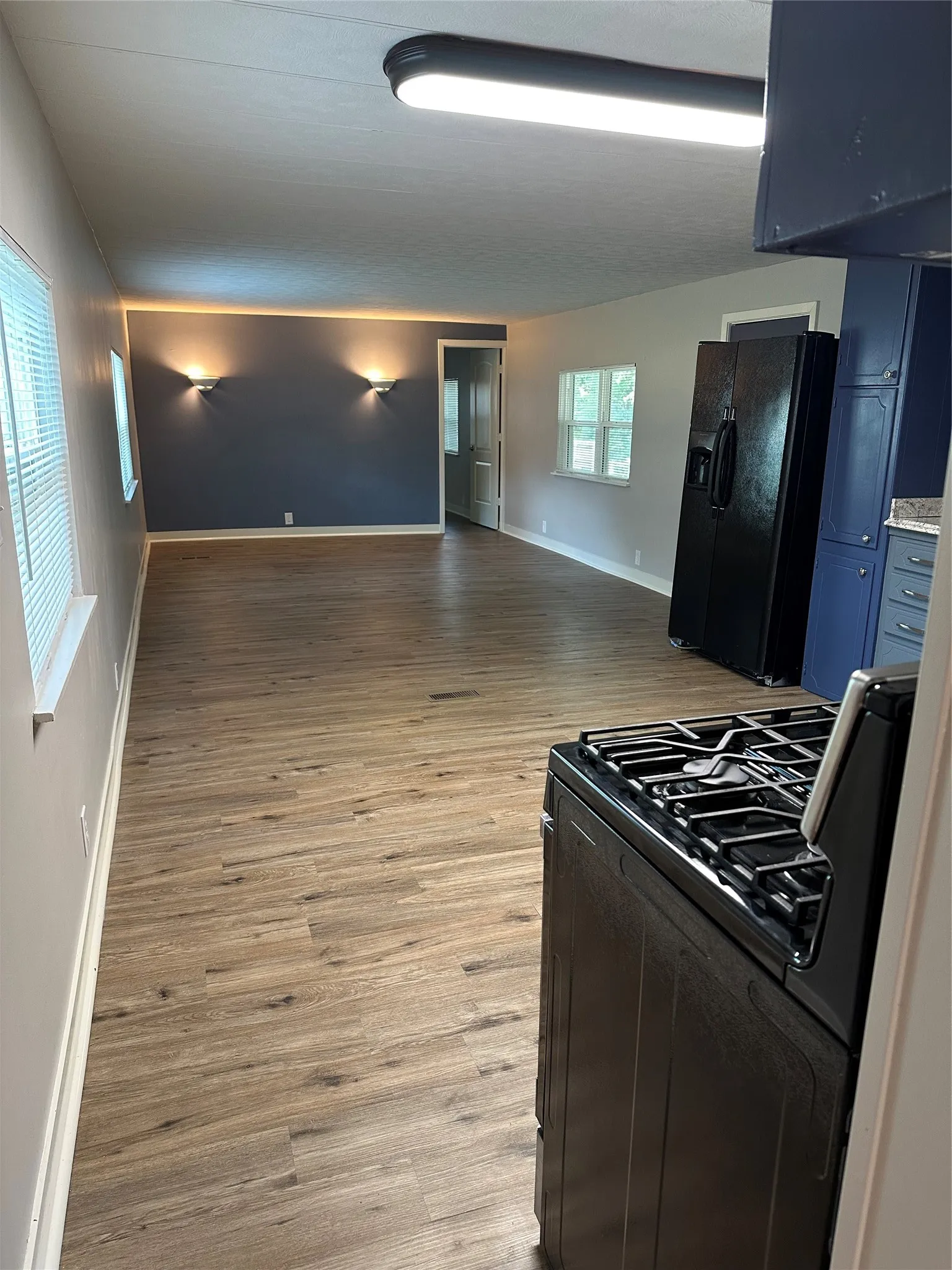 Large open floorplan combo of living room with eat-in kitchen.