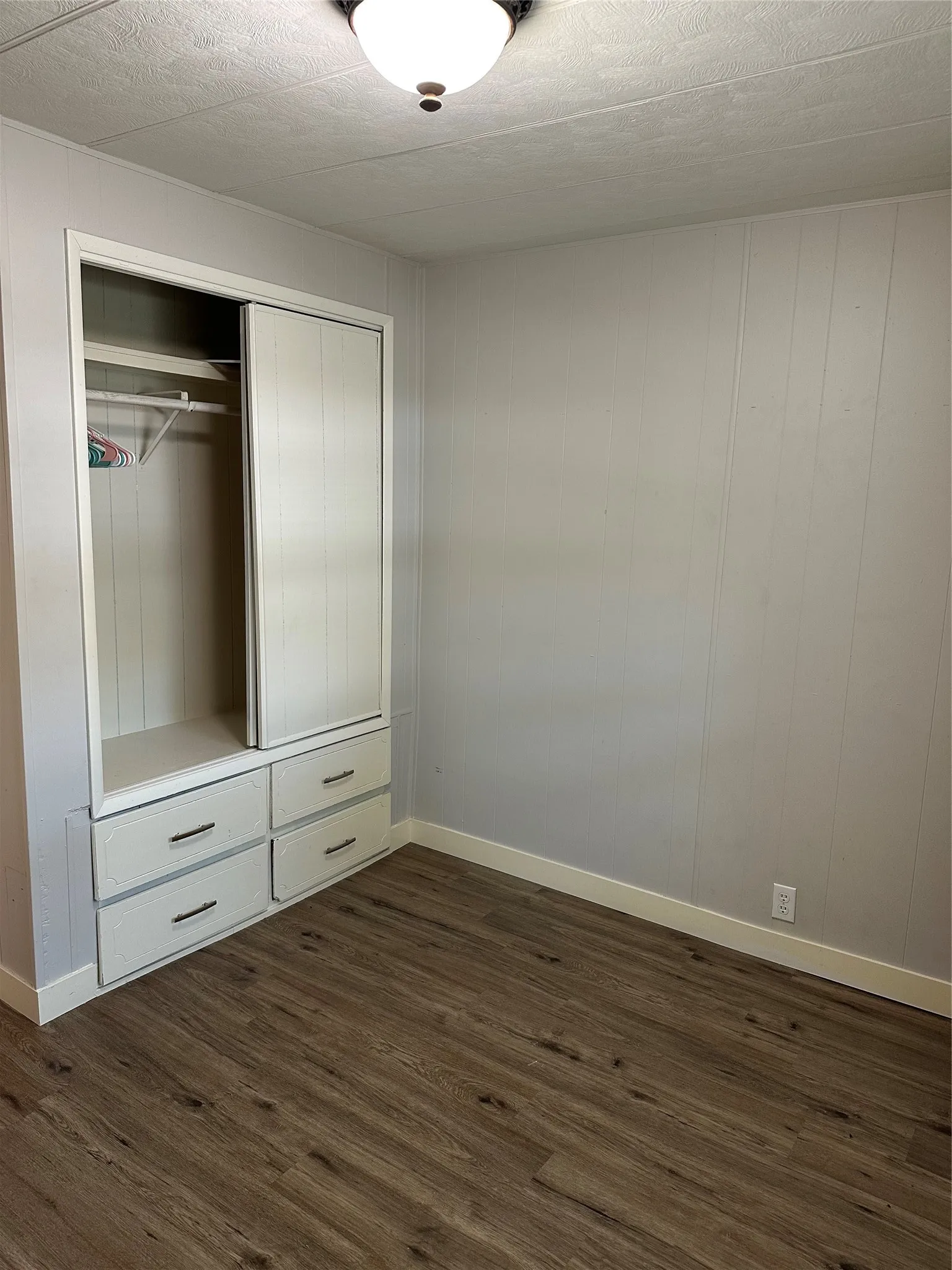 Closet area for 3rd bedroom with built in drawers for extra storage.