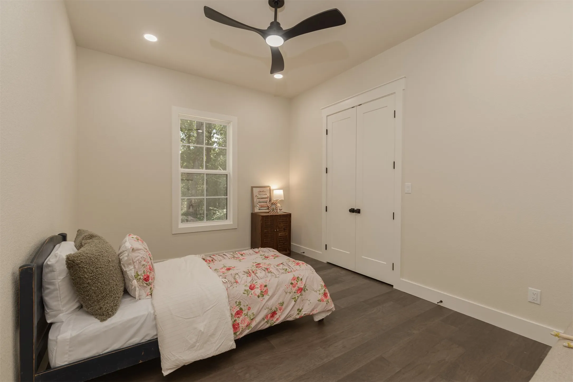 Recessed lighting, ceiling fan, wood-finish flooring, white trim, and white bi-fold closet doors
