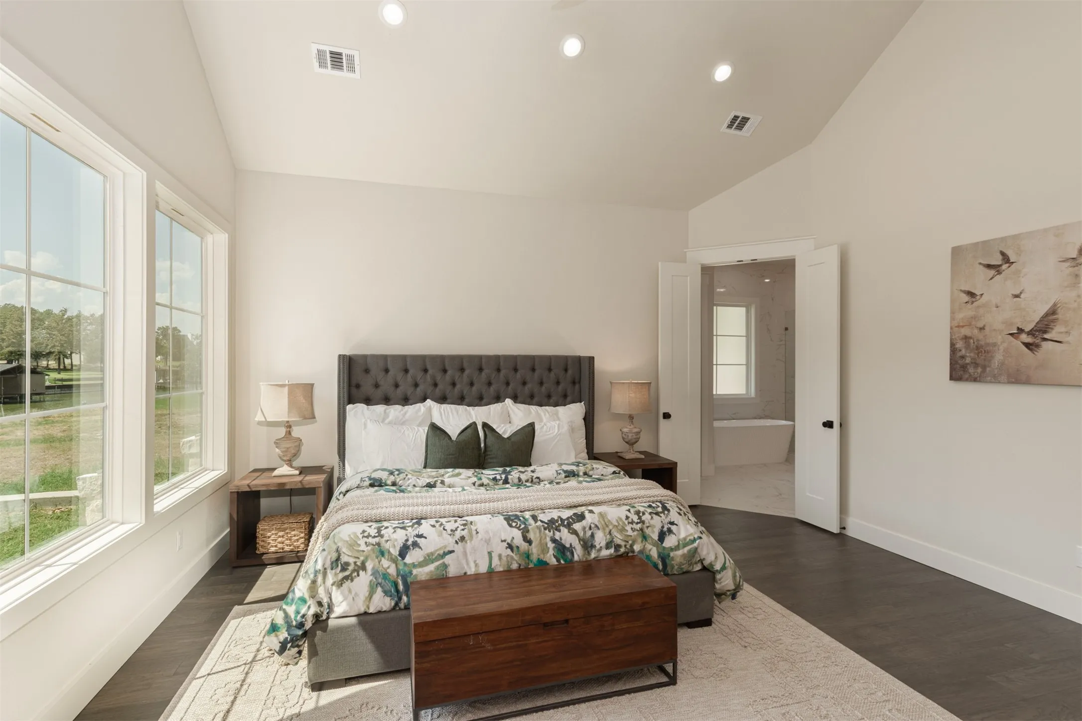 Vaulted ceiling, recessed lighting, double-pane windows, wood-finish flooring, and a private bathroom