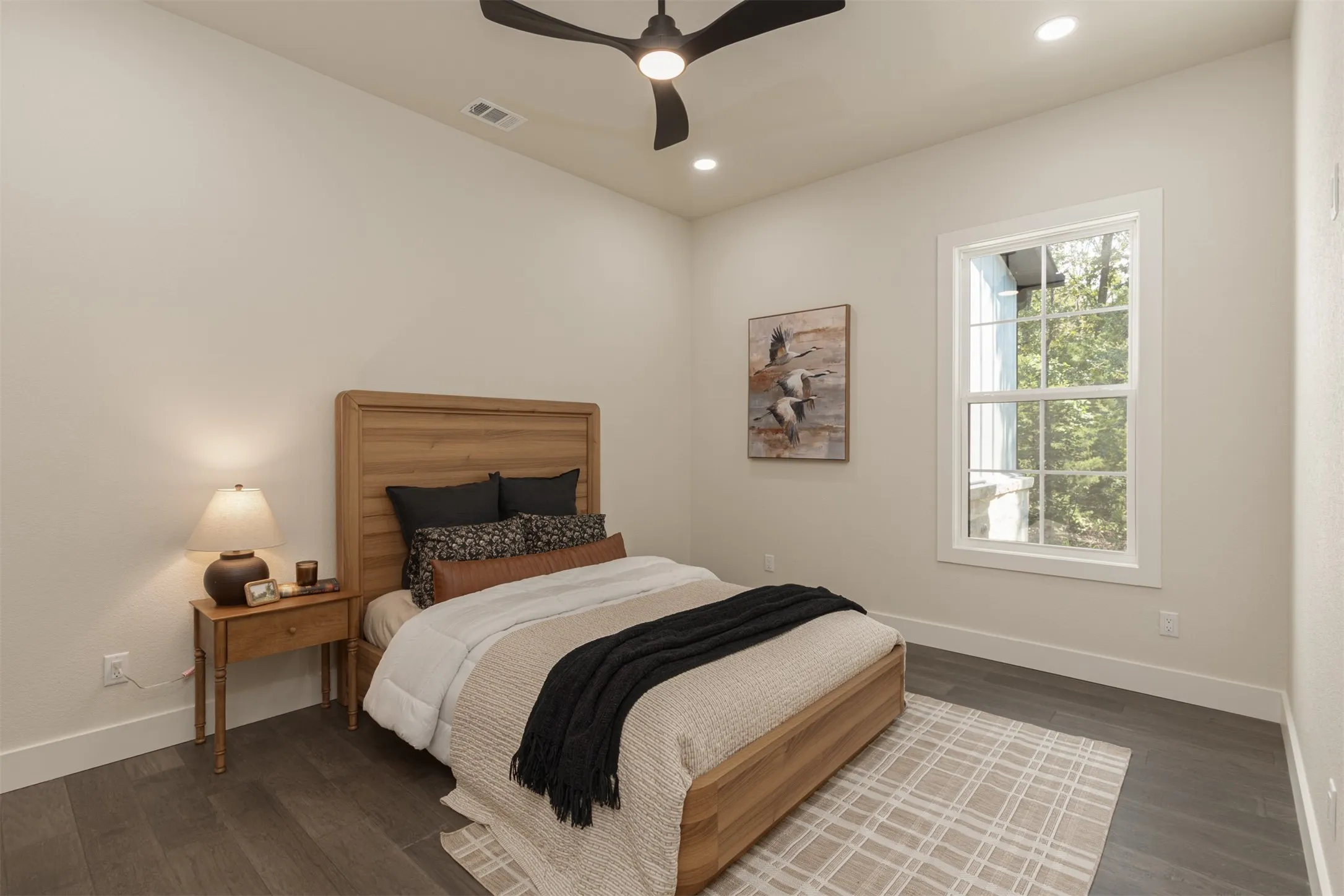 Vaulted ceiling with a ceiling fan, recessed lighting, wood-finish flooring, and a window with white trim
