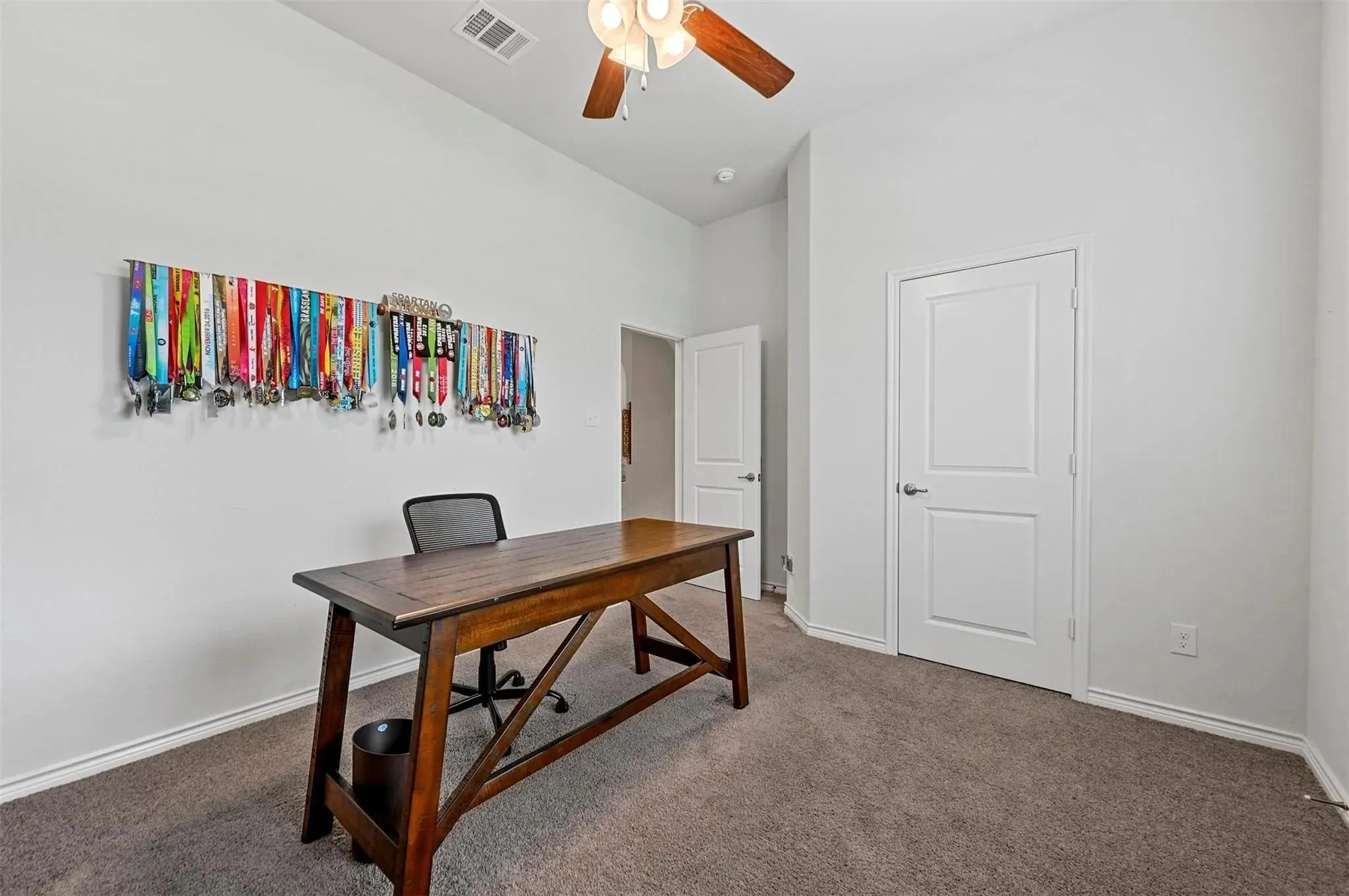 Recessed lighting, ceiling fan with light fixture, white interior doors, and carpet flooring