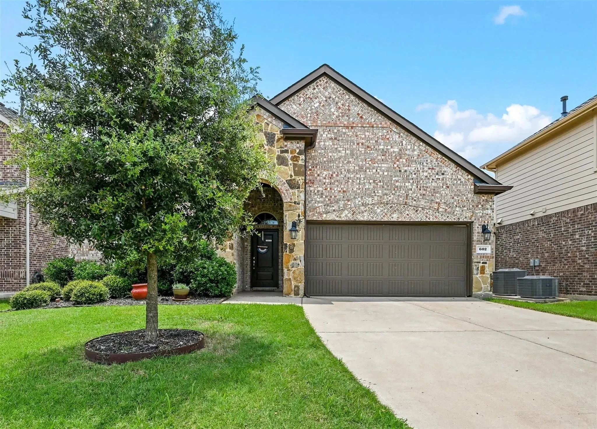 Brick and stone exterior with an arched entry