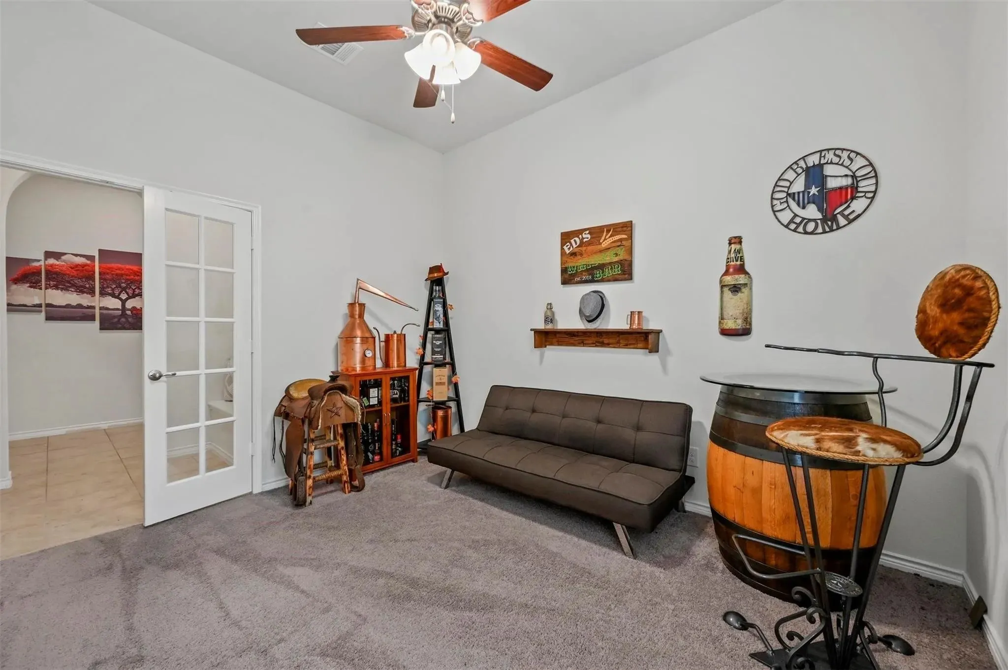 Carpeted room with high ceilings, a ceiling fan, and French doors