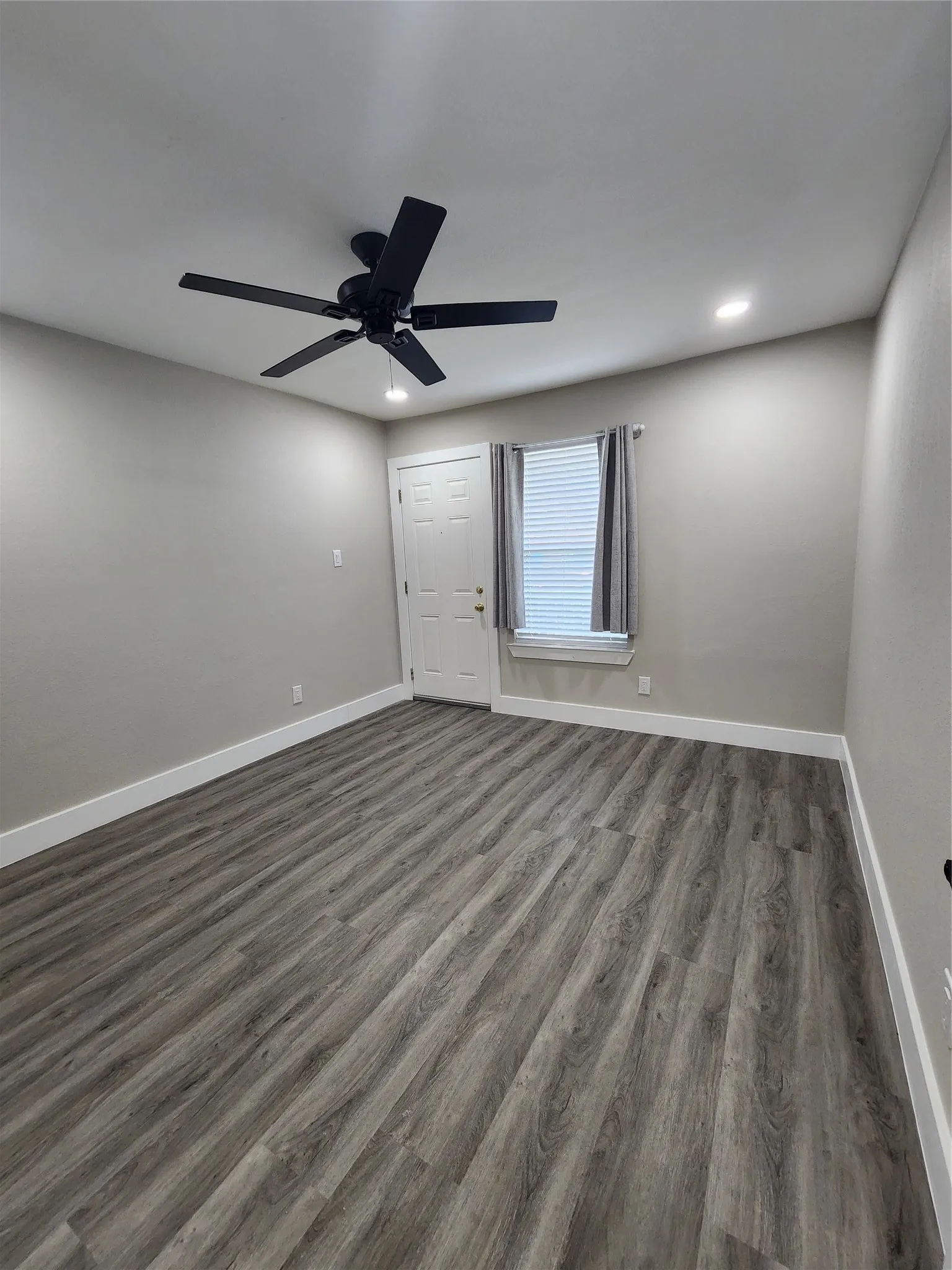 Wood-finish flooring, recessed lighting, and a contemporary ceiling fan