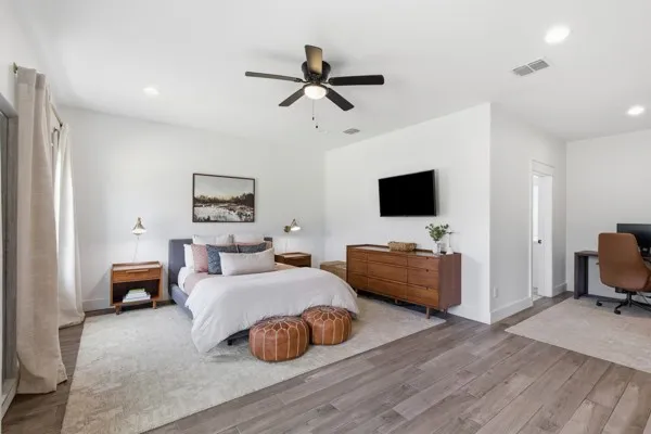 Wood-finish flooring throughout, recessed lighting, ceiling fan, and white walls