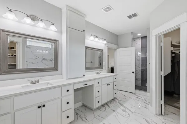 Dual vanities with white cabinetry, white countertops, and undermount sinks