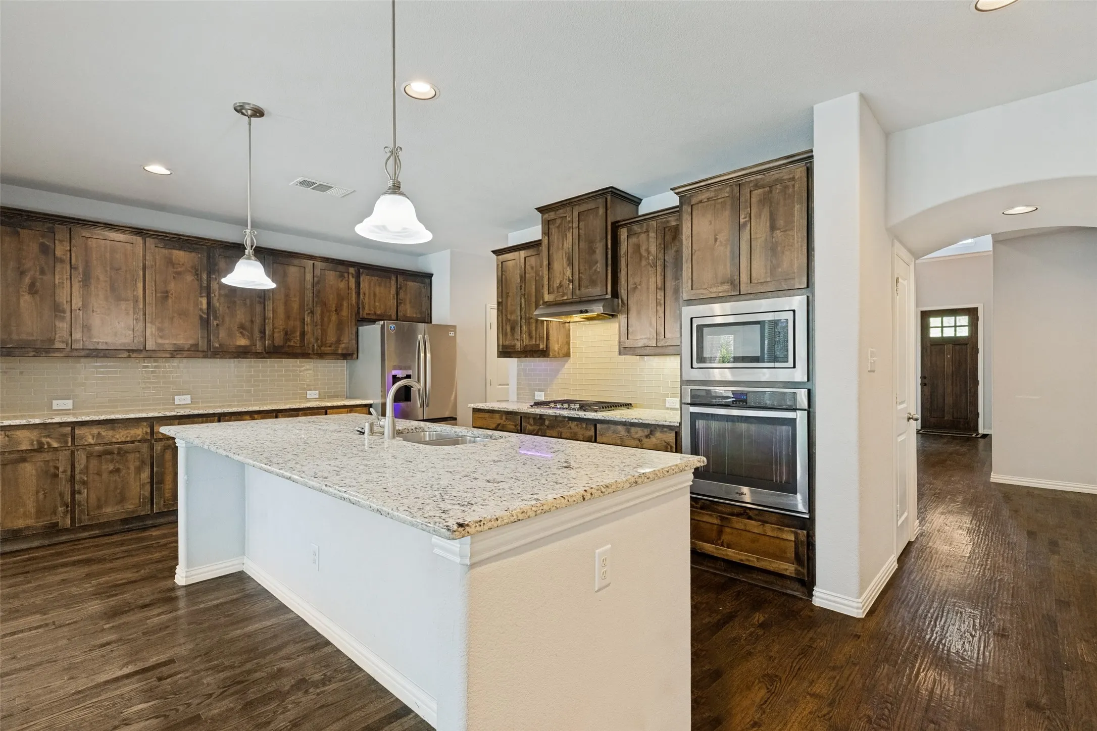Indulge in the culinary delight of the chef's kitchen, where a spacious eat-in island takes center stage, inviting you to gather and create cherished memories in this open and generously proportioned space.