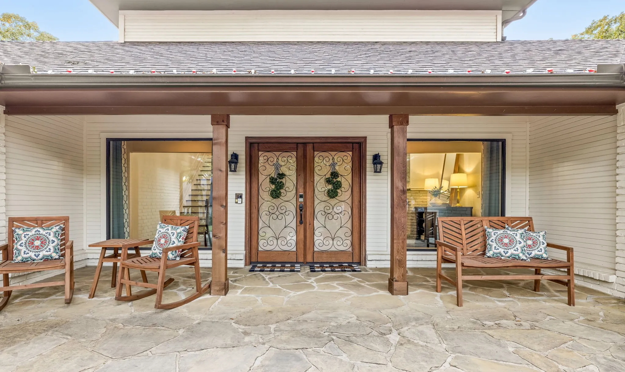 Flagstone patio featuring dark wood columns and a brown roofline