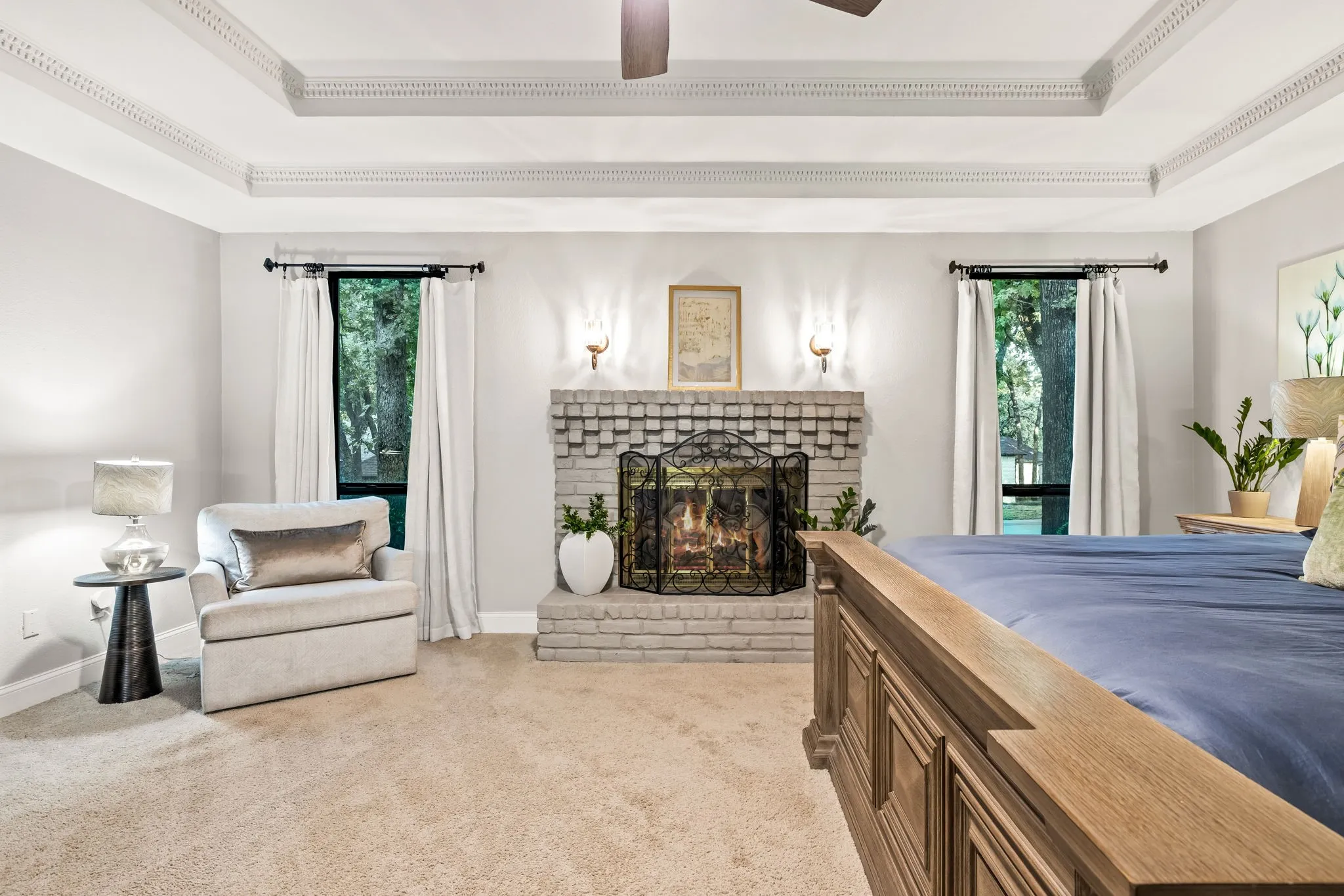 Tray ceiling with decorative molding, recessed lighting, and ceiling fan