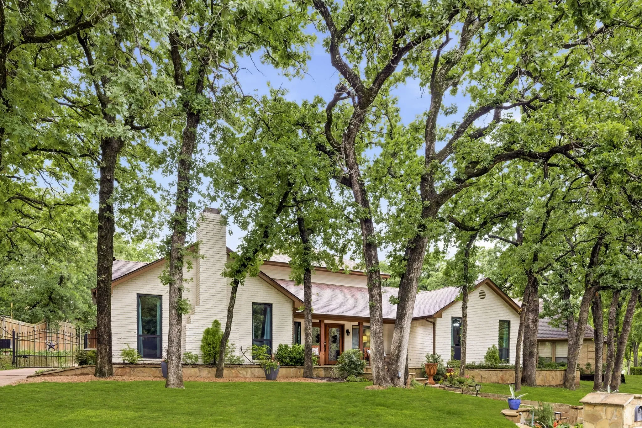 Single-story residence featuring a light brick exterior and a prominent chimney