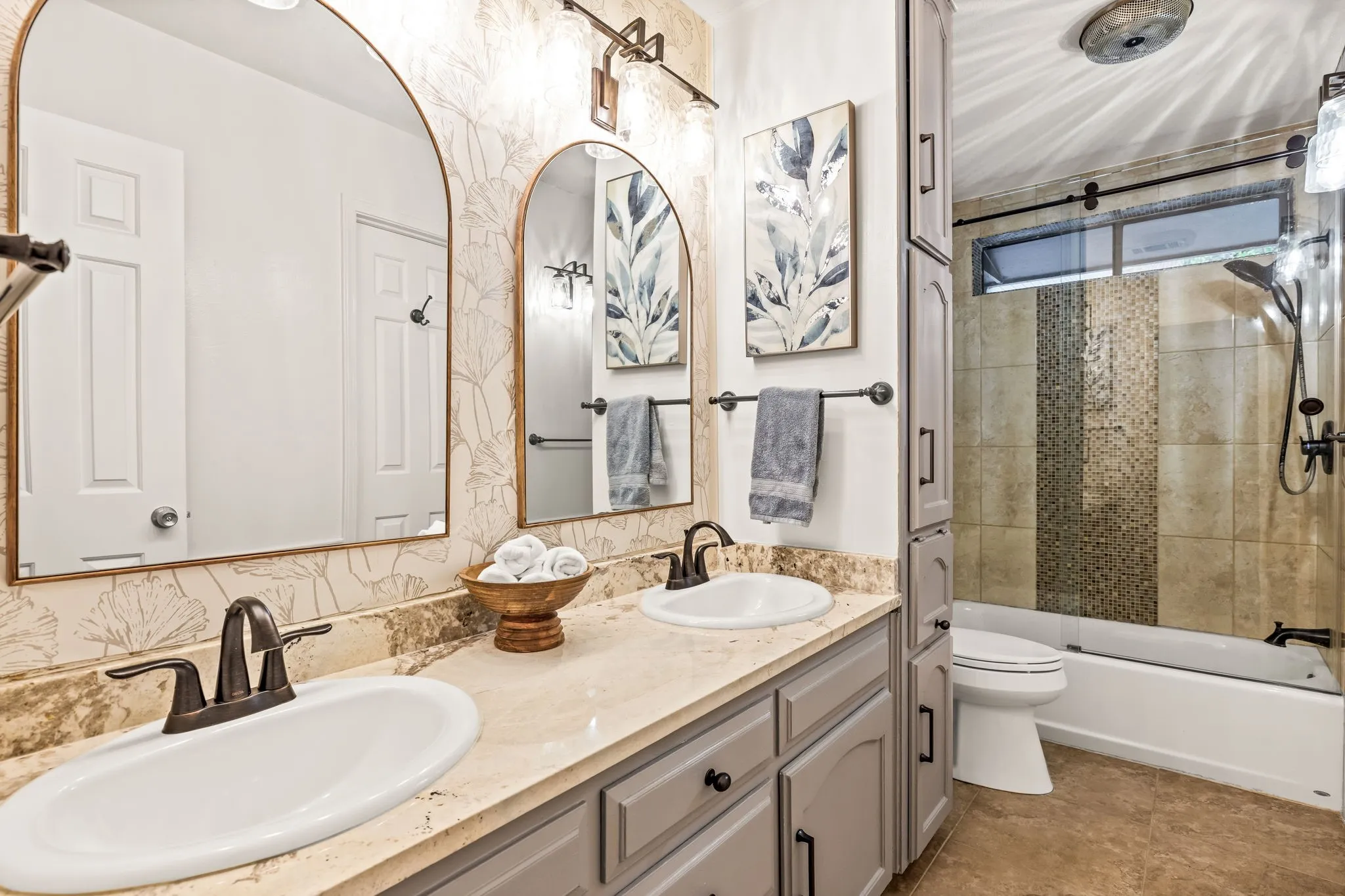 Double vanity with undermount sinks and bronze-finish fixtures