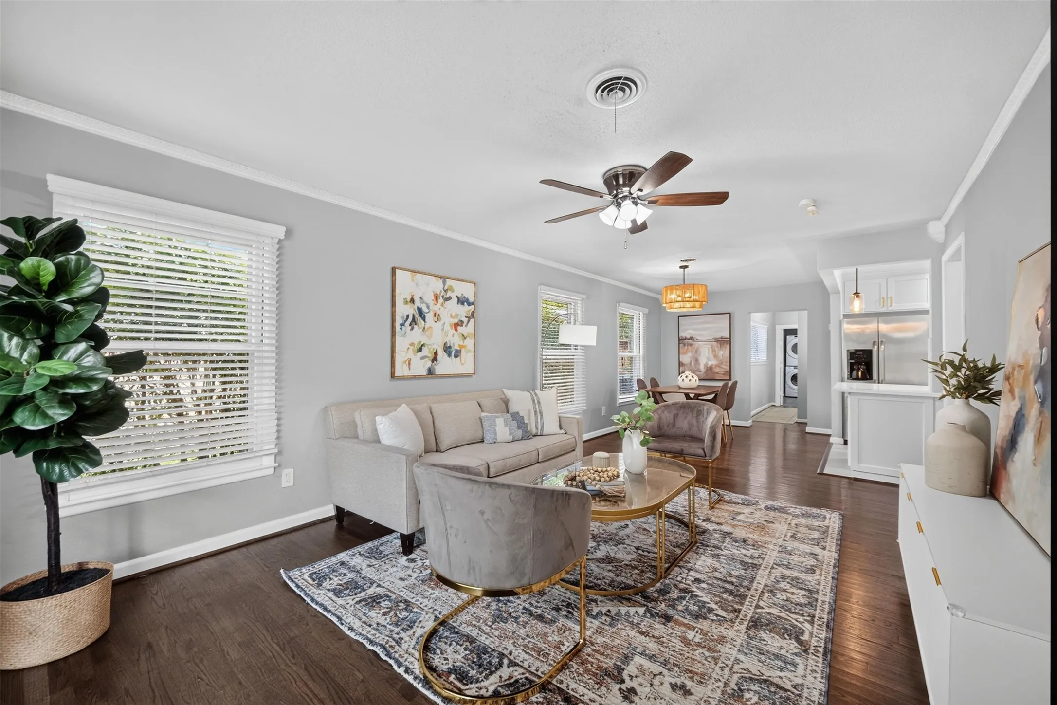 Dark wood-finish flooring, ceiling fan with light fixture, recessed lighting, white window blinds, and crown molding