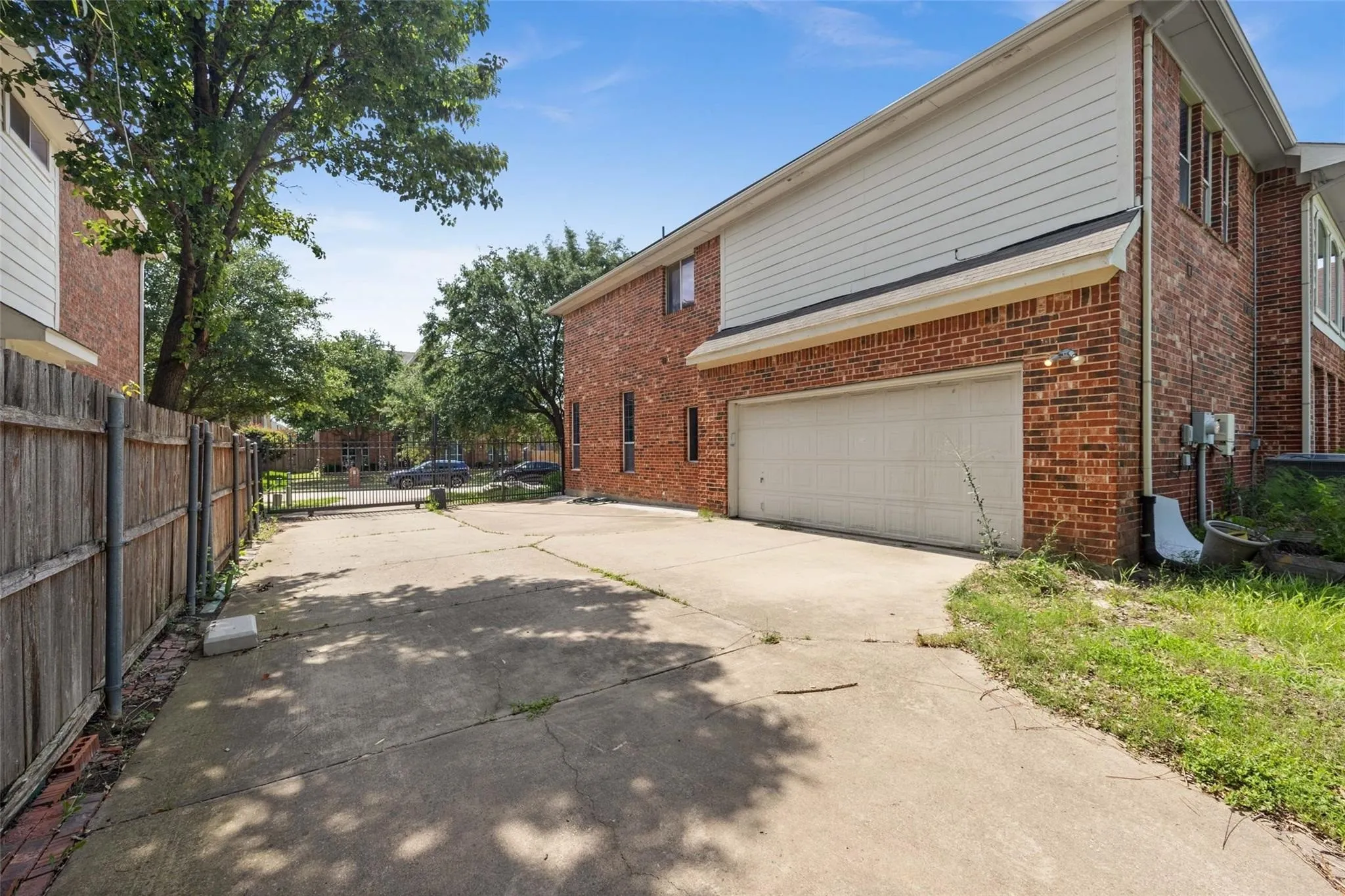 Brick exterior with white siding and an attached garage