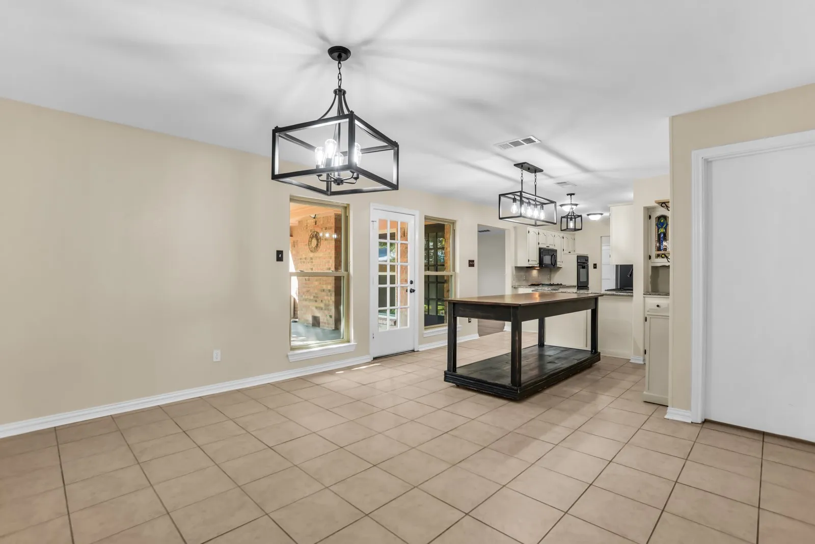 Tile flooring, recessed lighting, and multiple contemporary black-framed light fixtures