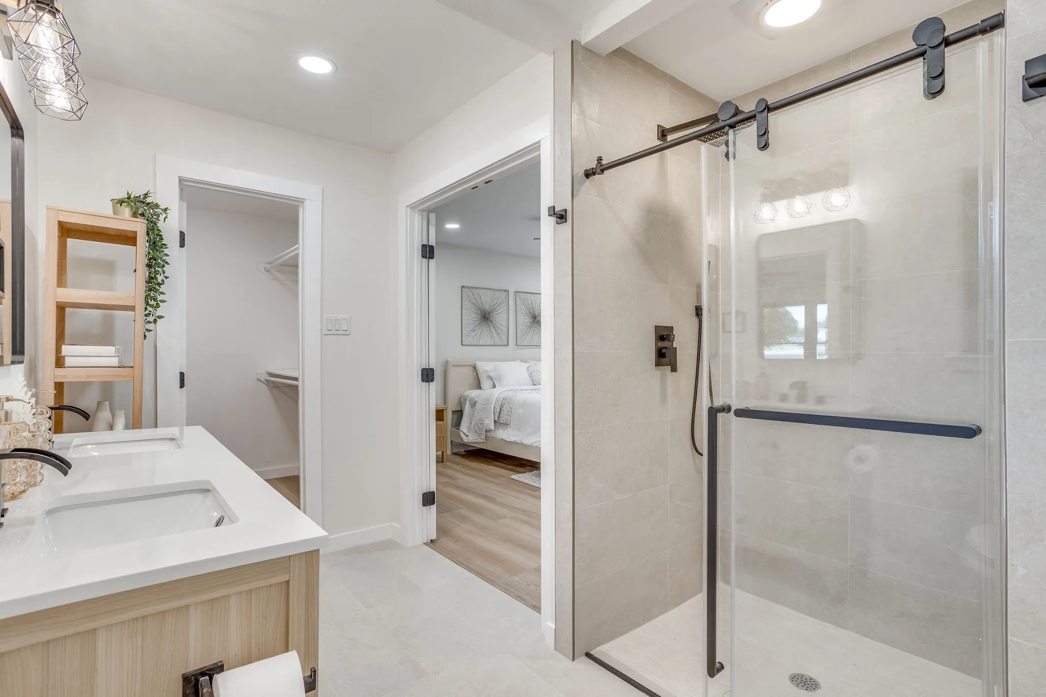 Dual vanity with integrated sinks, wood-finish cabinetry, and matte black fixtures