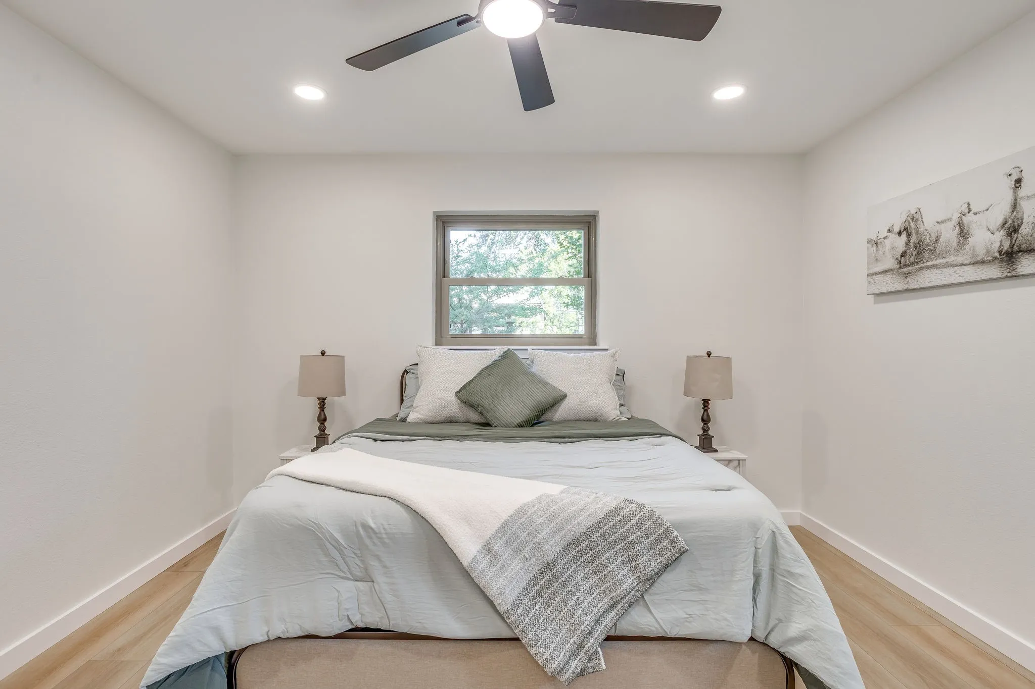 Recessed lighting, ceiling fan, wood-finish flooring, white walls, and a window with a grey frame